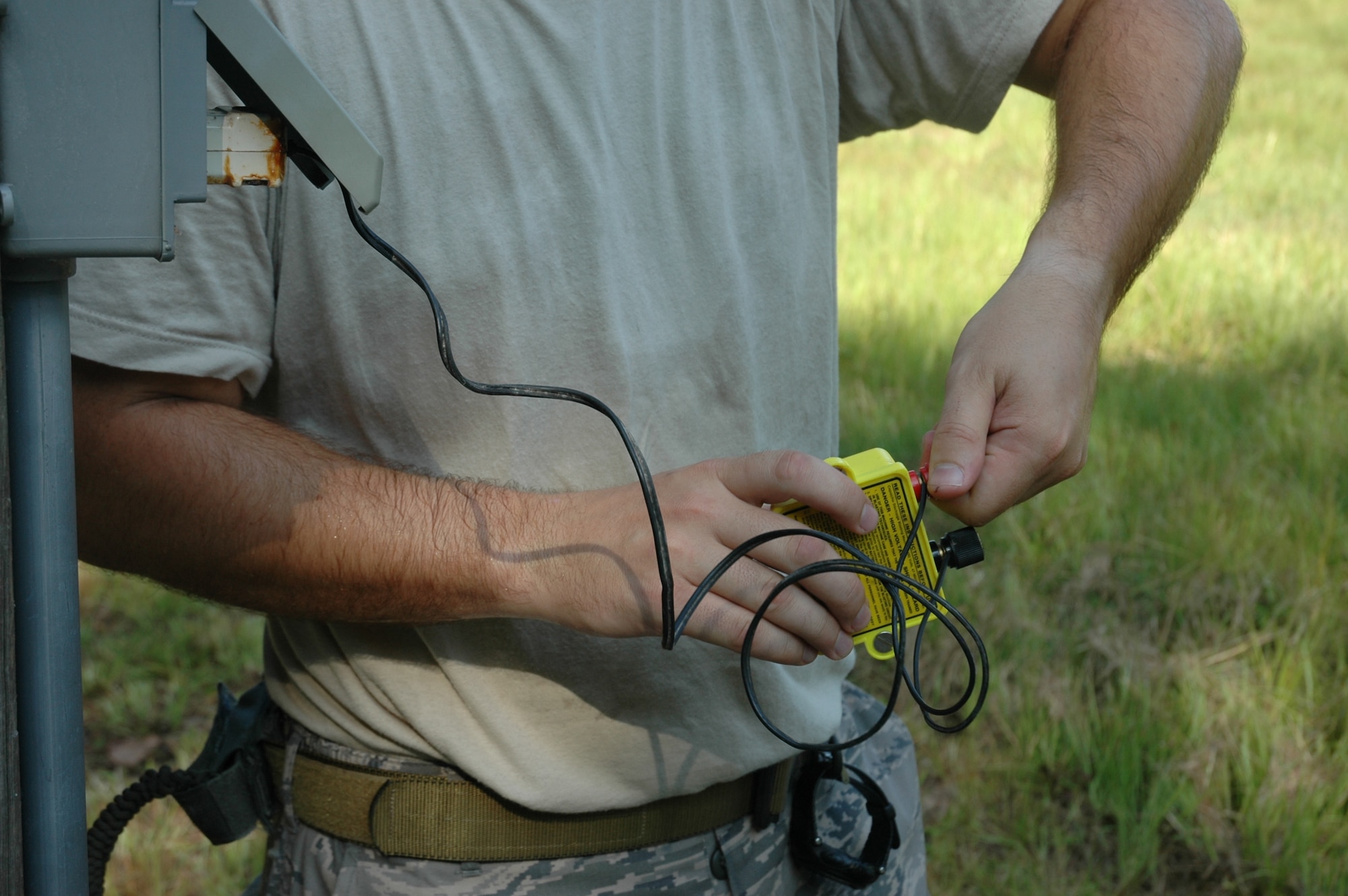 Tech. Sgt. Levi Kemp hooks up a firing device used to detonate C4 explosives August 7, 2010, at Charleston Air Force Base, S.C. Sergeant Kemp is an explosive ordnance disposal technician with the 315th Civil Engineering Flight, Explosive Ordnance Disposal unit. (U.S. Air Force photo/Maj. Bill Walsh)
