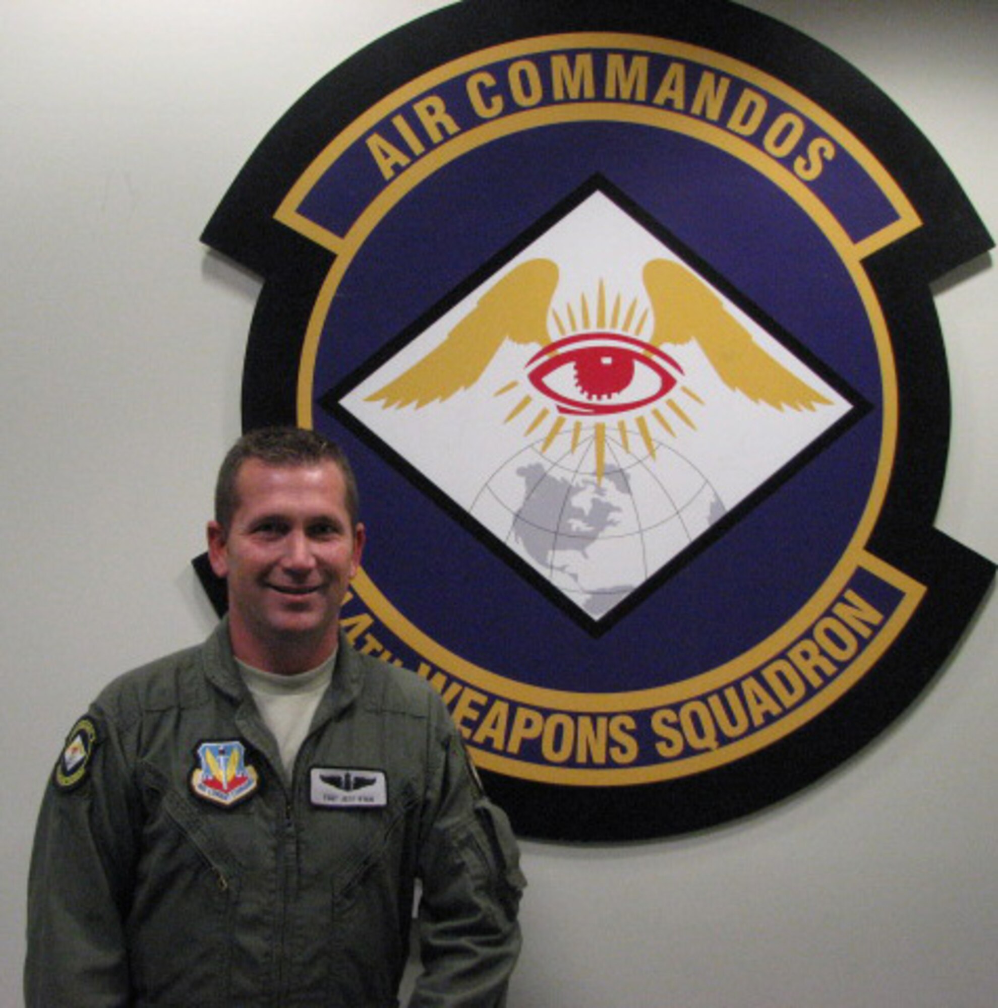 Tech Sgt. Robert Ryan, 14th Weapons Squadron Sensor operator, poses in front of the 14th WPS patch at his squadron's building at Hurlburt Field, Fla. Sergeant Ryan was selected for this week's "Tip of the Spear" spotlight. 