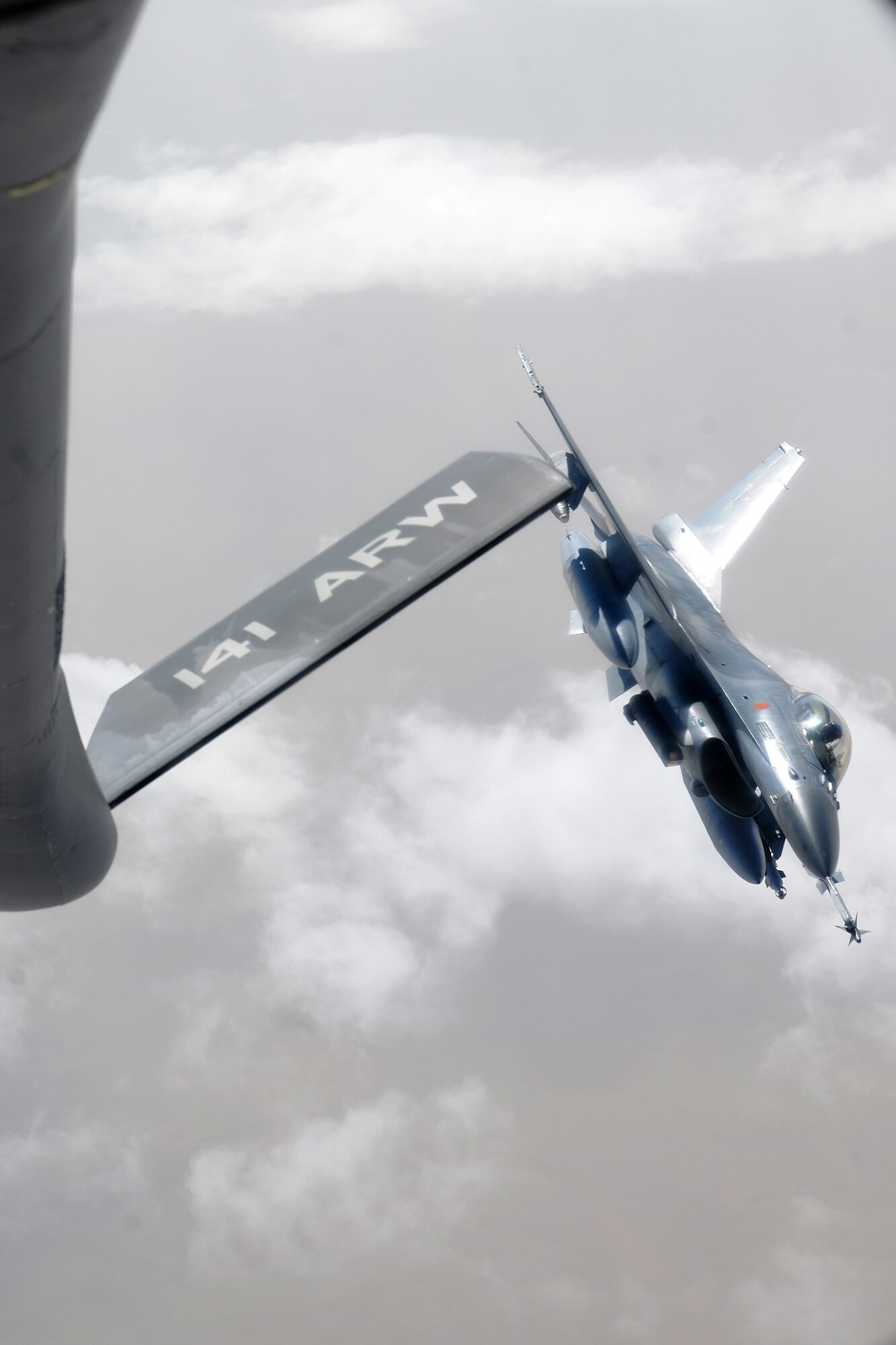 TRANSIT CENTER AT MANAS, Kyrgyzstan - A Belgium Air Force F-16 Fighting Falcon fly's away after receiving fuel from a KC-135 Stratotanker over Afghanistan Aug. 8.  The KC-135 is deployed from the 92d Air Refueling Wing from Fairchild Air Force Base, Washington.  (U.S. Air Force photo/Staff Sgt. Nathan Bevier)