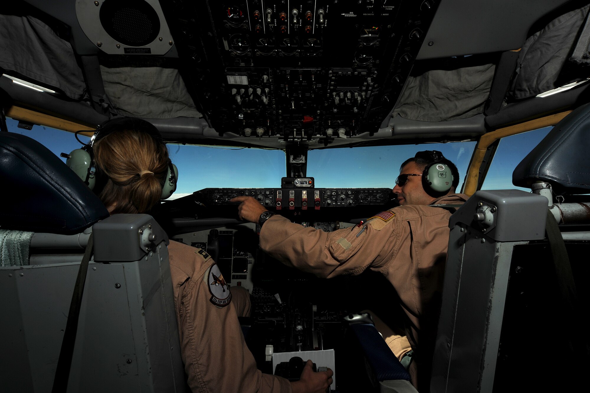 TRANSIT CENTER AT MANAS, Kyrgyzstan - Capt. Jeff Jacques (right), instructor aircraft commander, directs the attention of Capt. Brittany Gilmer, KC-135 Stratotanker pilot, toward the next aircraft requiring air refueling Aug. 8.  Both are deployed from the 93d Air Refueling Squadron at Fairchild Air Force Base, Wash.  (U.S. Air Force photo/Staff Sgt. Michael Schocker)