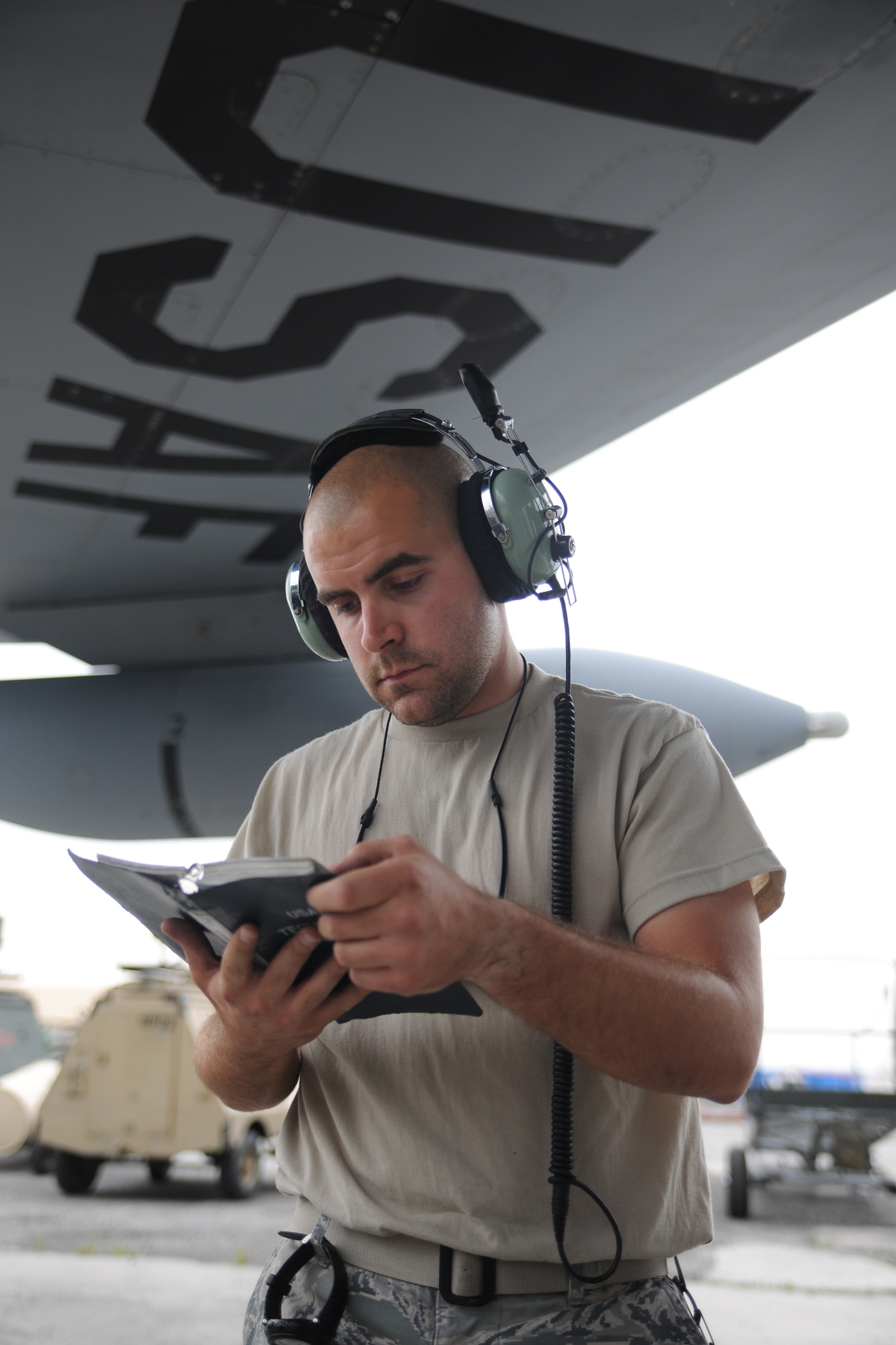TRANSIT CENTER AT MANAS, Kyrgyzstan ?  Tech. Sgt. David Ames, guidance and control systems technician deployed from Grand Forks AFB, reviews technical orders for a KC-135 Stratotanker Aug. 6.  The KC-135 is deployed from Fairchild Air Force Base, Wash. (U.S. Air Force Photo/Staff Sgt. Nathan Bevier)