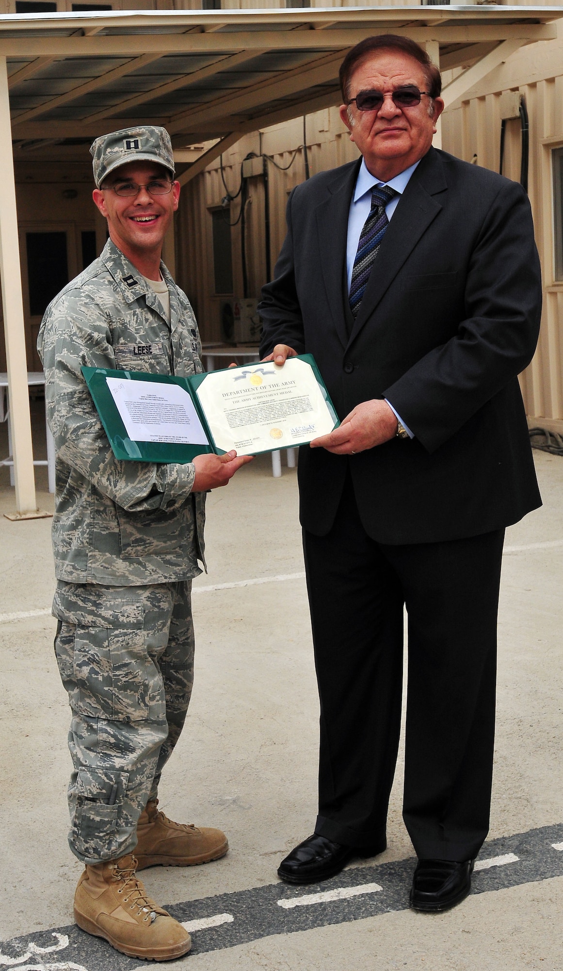 100810-N-6031Q-007 KABUL, Afghanistan - Capt. Robert Leese, 438th Air Expeditionary Wing, stands with Ministry of Defense Abdul Rahim Wardak displaying his award certificate for the Army Achievement medal presented to him during an award presentation held at the Afghan Air Force base in Kabul, Afghanistan on Aug. 10, 2010. The award presentation was in recognition of U.S. Air Force Airmen who have had a significant impact on the CAPTF mission in Afghanistan over the last several months. (US Navy photo by Mass Communication Specialist 2nd Class David Quillen/ RELEASED).