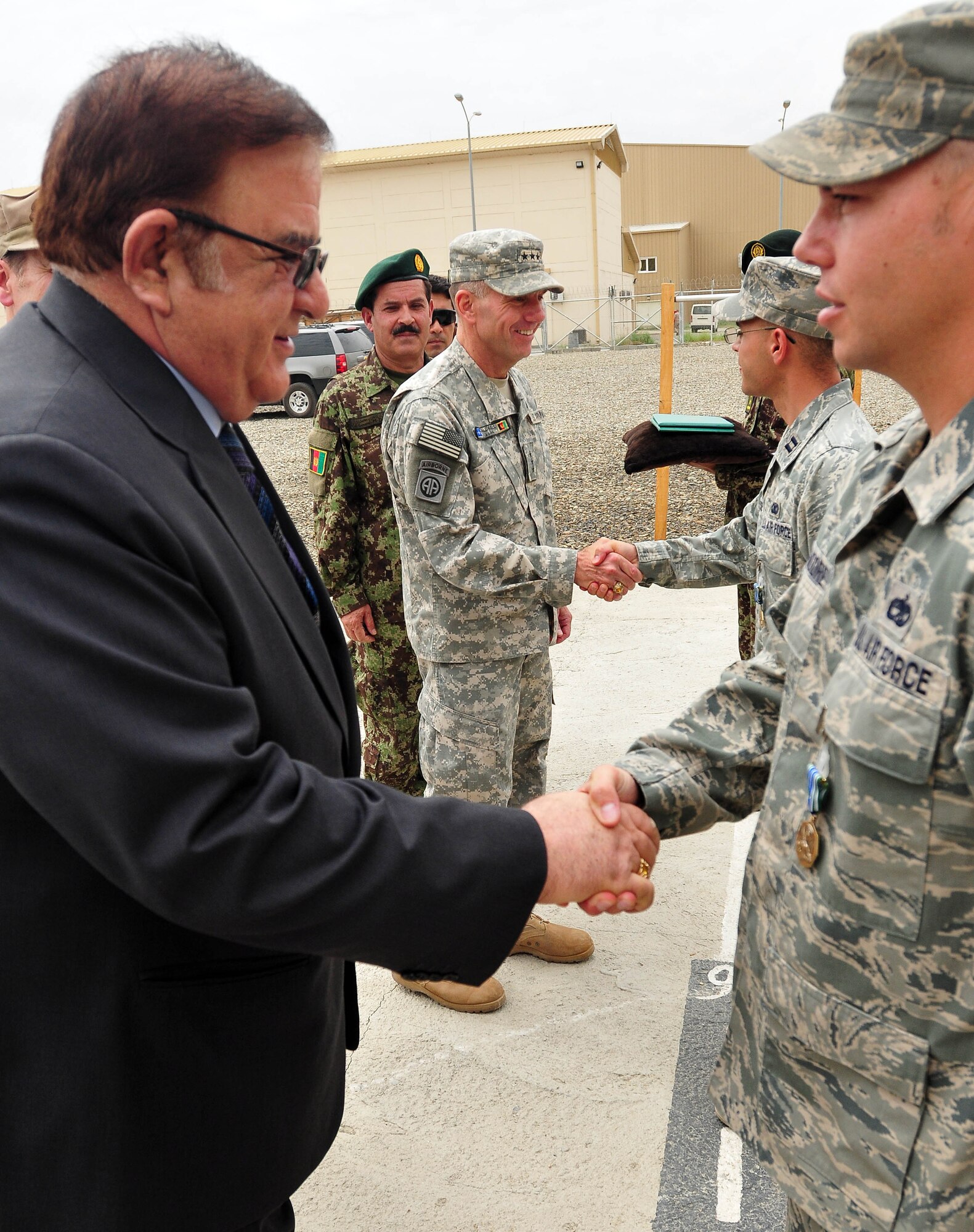 100810-N-6031Q-006 KABUL, Afghanistan - Ministry of Defense Abdul Rahim Wardak congratulates TSrgt. Robert Moore, 438th Air Expeditionary Advisery Group, as Lt. Gen. William B. Caldwell, Commanding General, NATO Training Mission, Combined Security Transition Command -Afghanistan, congratulates Capt. Robert Leese, 438th Air Expeditionary Wing, during an award presentation held at the Afghan Air Force base in Kabul, Afghanistan on Aug. 10, 2010. The award presentation was in recognition of U.S. Air Force Airmen who have had a significant impact on the CAPTF mission in Afghanistan over the last several months. (US Navy photo by Mass Communication Specialist 2nd Class David Quillen/ RELEASED).