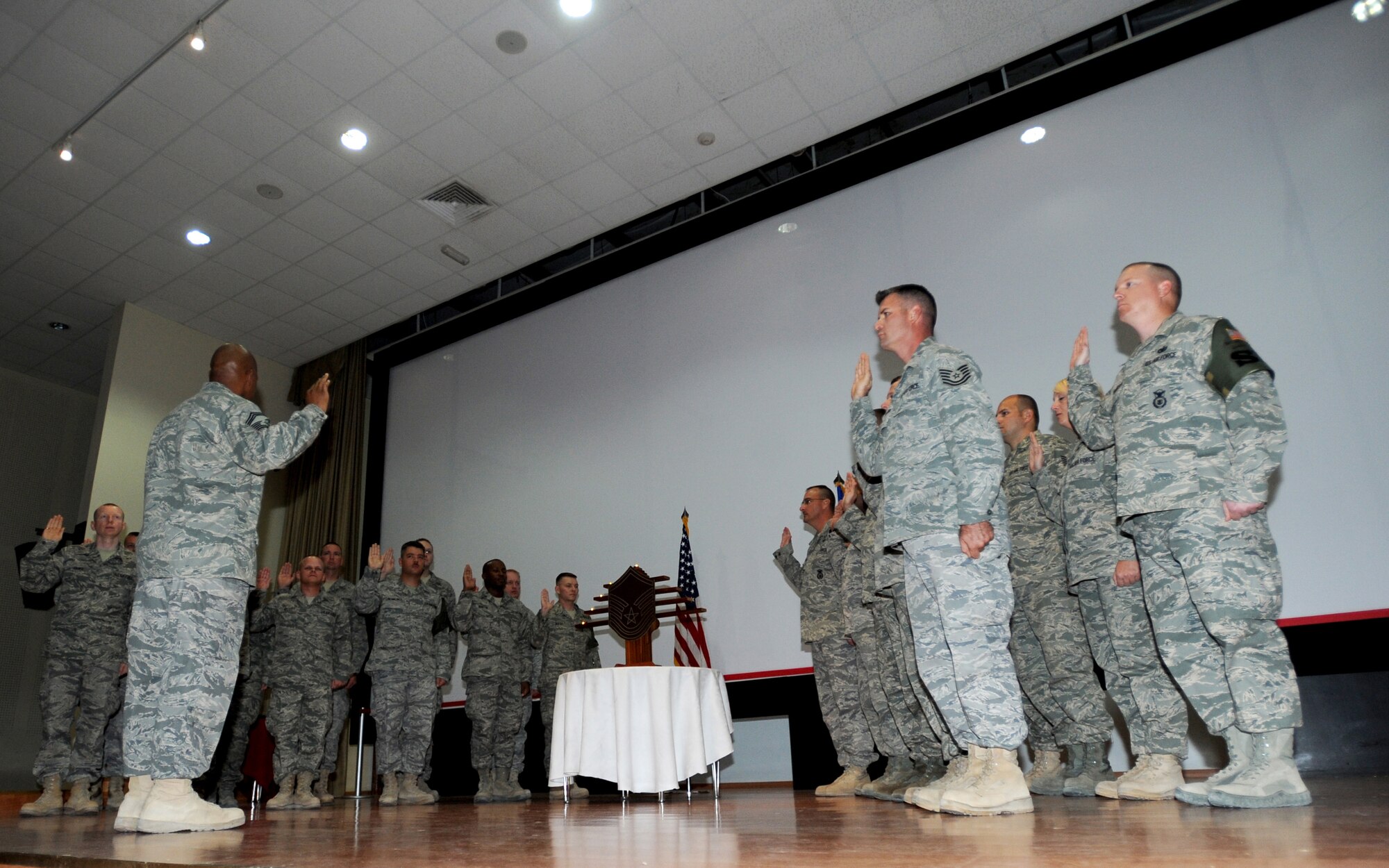 SOUTHWEST ASIA - Newly promoted master sergeants and master sergeant (selects) are sworn in during a Senior NCO Induction Ceremony at an undisclosed are base here August 8, 2010. The ceremony recognized Airmen who have been promoted to the tops tiers of the enlisted ranks, signifying the levels of accomplishment each inductee has achieved in the Air Force. (U.S. Air Force photo by Senior Airman Laura Turner)