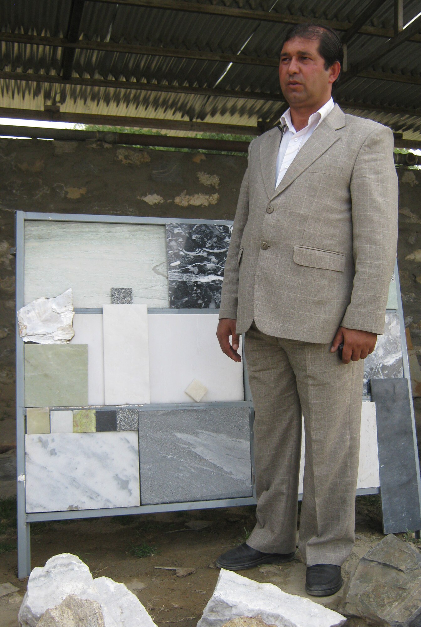 Ghulam Nabi Yaqoobi, director of the Ghulam Nabi Yaqoobi Construction and Road Construction Company, talks about some of the marble samples his company produces. Yaqoobi runs the only legitimate marble mining operation in the Panjshir Province, Afghanistan, and he is looking for investors to expand his business. (Photo by U.S. Air Force 2nd Lt. Jason Smith, PRT Panjshir Public Affairs)