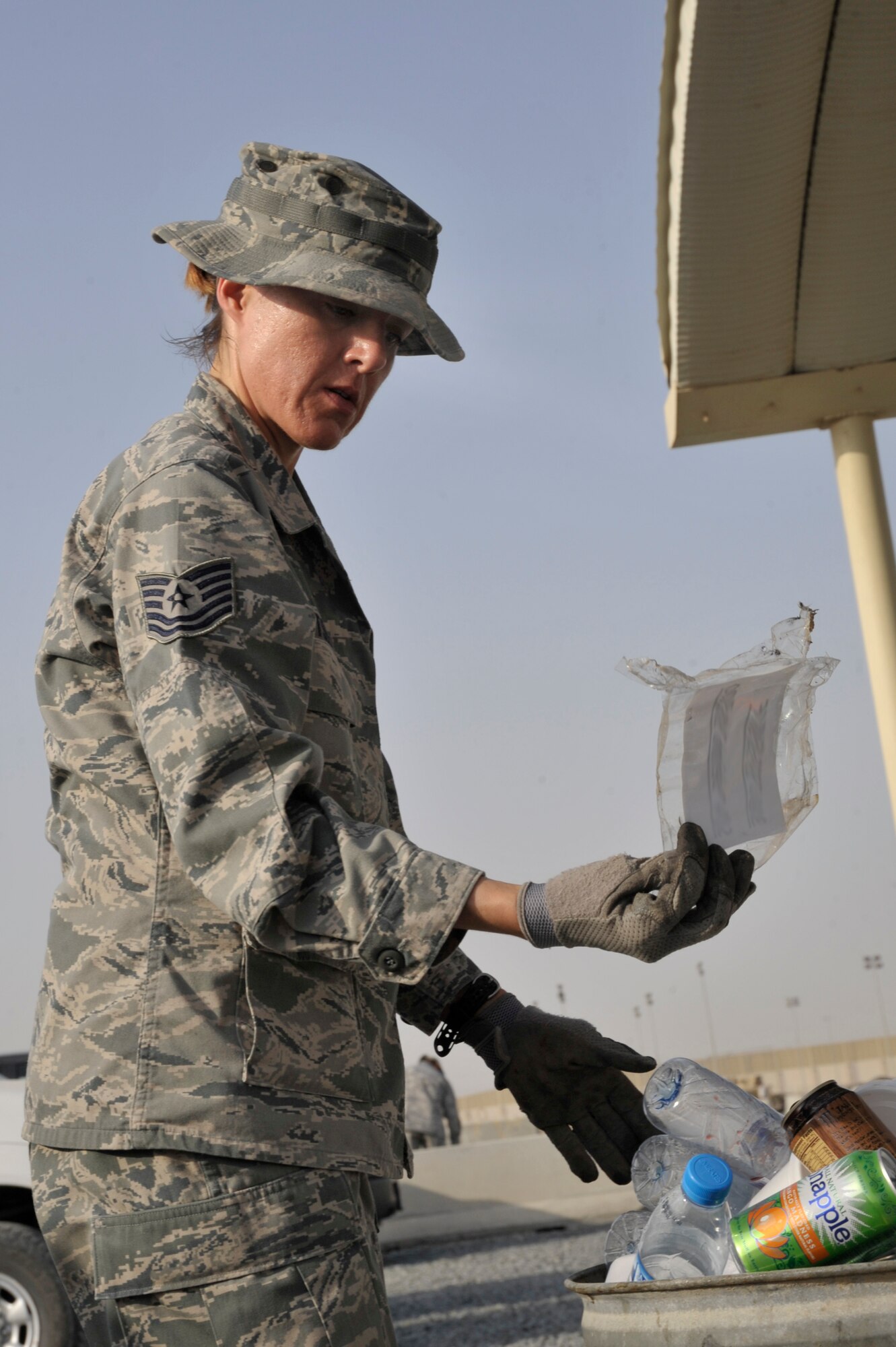 Tech. Sgt Yvonne Hootselle, 380th Air Expeditionary Wing NCO in charge antiterrorism intelligence finds and address label in a trash can Aug. 8 at an undisclosed location in Southwest Asia.  All paper and sticky notes, whether written on or not , address labels, customs forms, duty rosters, manning rosters, anything talking about aircraft, and anything written about aircraft, and anything with your name or unit must be shredded. The only paper products that can we thrown away here are food wrappers if not written on, newspapers and magazines with the mailing address removed. (U.S. Air Force photo/Tech. Sgt. April Wickes)



