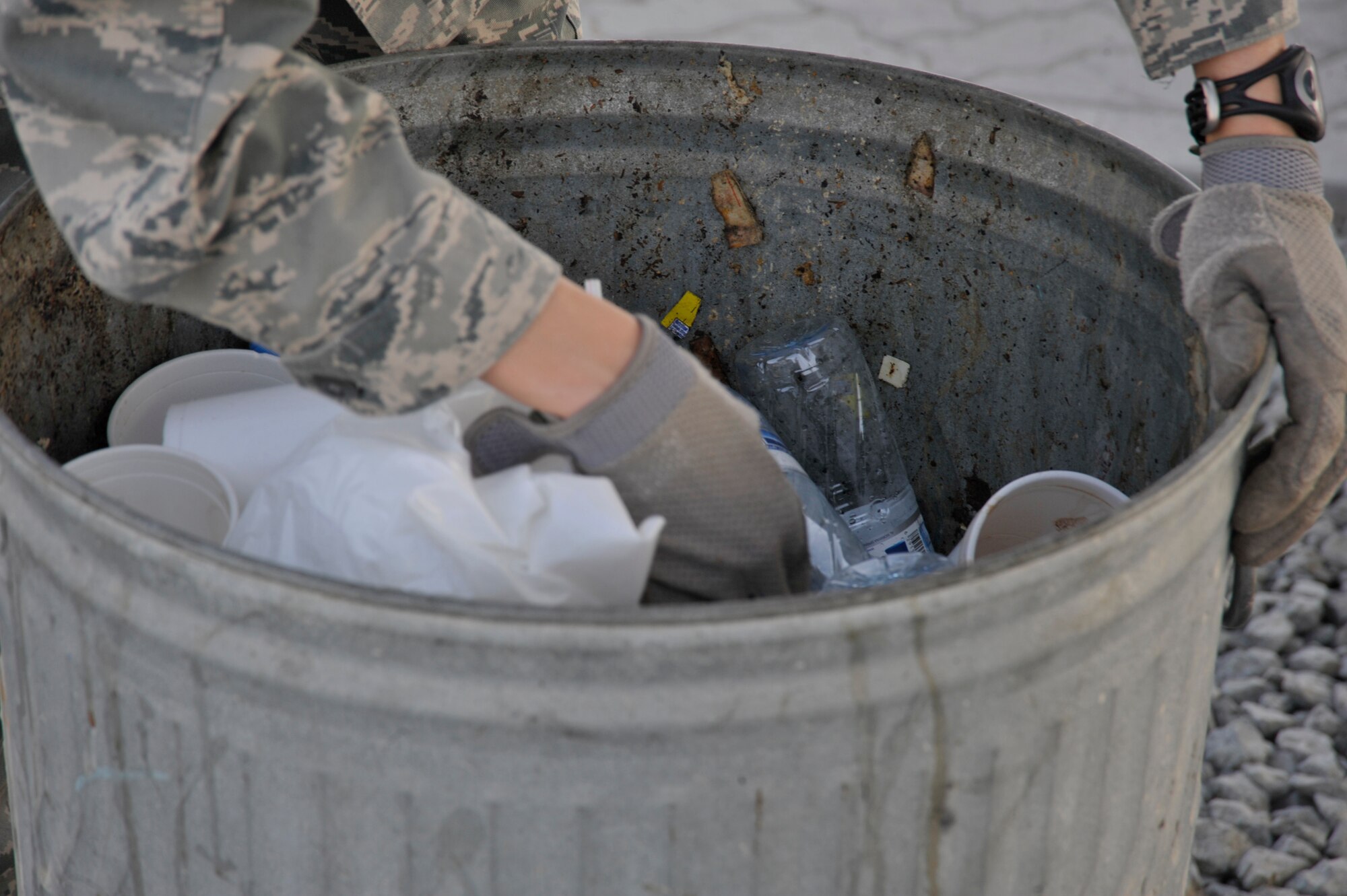 Tech. Sgt Yvonne Hootselle, 380th Air Expeditionary Wing NCO in charge antiterrorism intelligence, looks through a trash can to see if anyone has improperly disposed of OPSEC material Aug. 8 at an undisclosed location in Southwest Asia.  All paper and sticky notes, whether written on or not , address labels, customs forms, duty rosters, manning rosters, anything talking about aircraft, and anything written about aircraft, and anything with your name or unit must be shredded. The only paper products that can we thrown away here are food wrappers if not written on, newspapers and magazines with the mailing address removed. (U.S. Air Force photo/Tech. Sgt. April Wickes)



