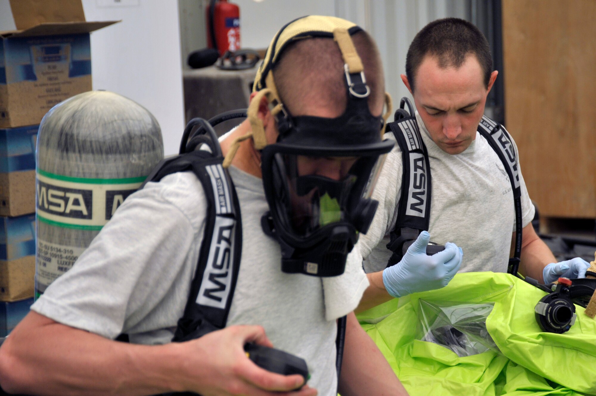 Airman 1st Class Tyler Aldrich and Senior Airman Brad Turner, 380th Civil Engineer Squadron emergency management journeymen, ensure their equipment is in working order during a hazardous response exercise at an undisclosed location in Southwest Asia Aug 7. (U.S. Air Force Photo/Tech. Sgt. April Wickes) 