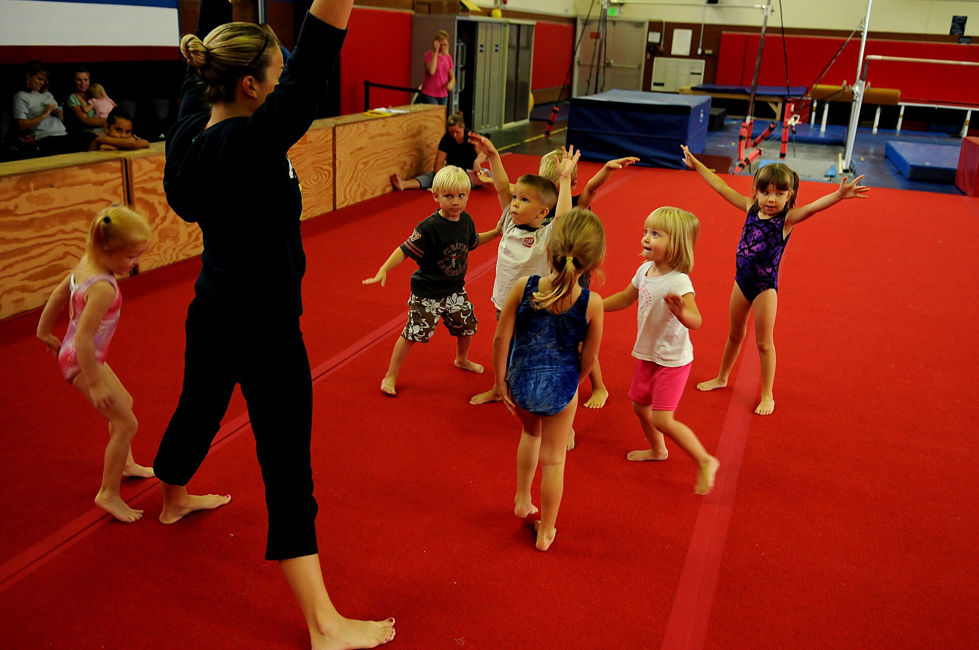 Gymnastics instructor Nicole Adams teaches pre-school students how to cool down after a gymnastics workout offered by the Kadena Youth Center, Aug. 9, 2010, at Kadena Air Base, Japan.The Kadena Youth Center offers more than 200 instructional classes for approximately 1,700 youth ranging in ages from 18 months to 18 years. (US Air Force photo/Staff Sgt. Christopher Hummel)