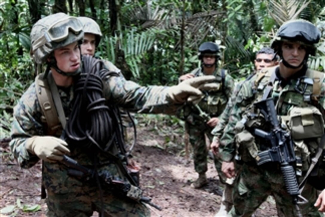 U.S. Marine Corps Cpl. Blaho instructs his squad on where to cross a river while training with Colombian marines on jungle warfare in Colombia on Aug. 2, 2010.  The Marines are participating in Partnership of the Americas/Southern Exchange, a combined amphibious exercise designed to enhance cooperative partnerships with participating maritime forces.  Blaho is with 4th Platoon, Charlie Company, 3rd Assault Amphibian Battalion, 1st Marine Division.  