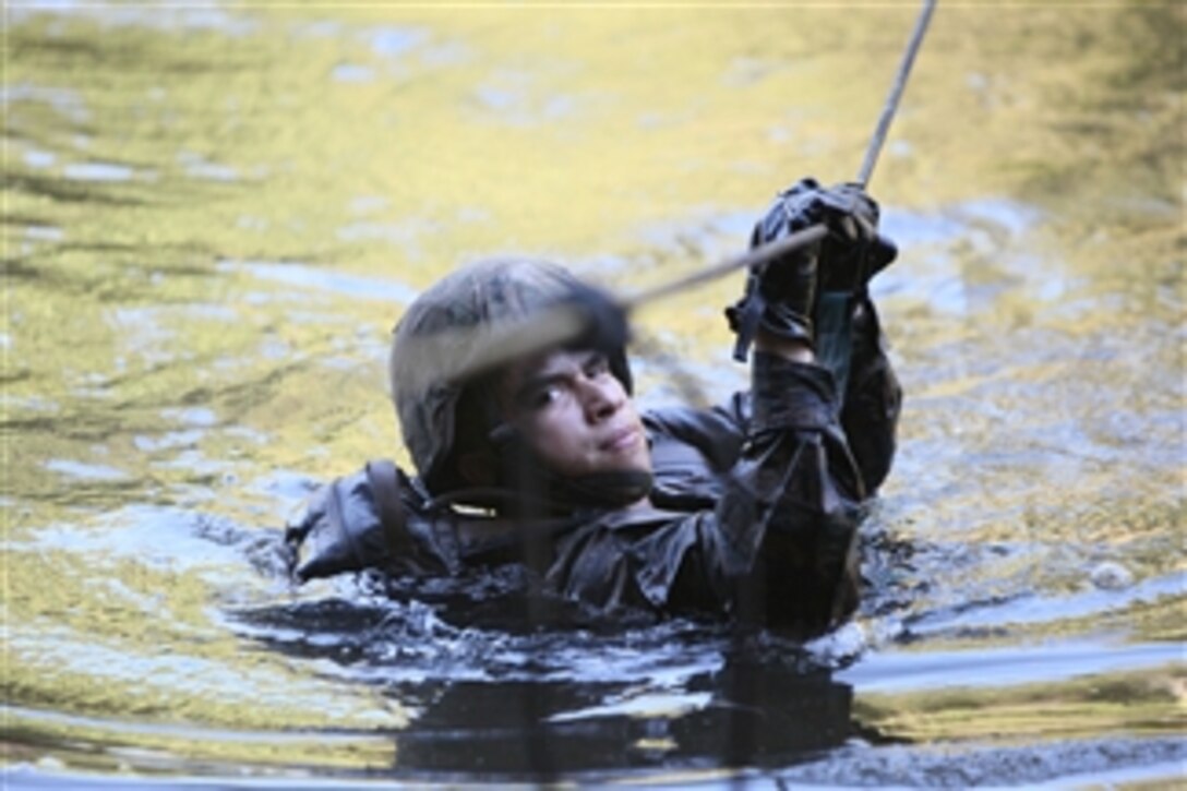 A U.S. Marine with 4th Platoon, Charlie Company, 3rd Assault Amphibian Battalion, 1st Marine Division crosses a river during jungle warfare training in Colombia on Aug. 2, 2010.  The Marine is deployed to support operation Partnership of the Americas/Southern Exchange, a combined amphibious exercise designed to enhance cooperative partnerships with maritime forces from nine other nations.  