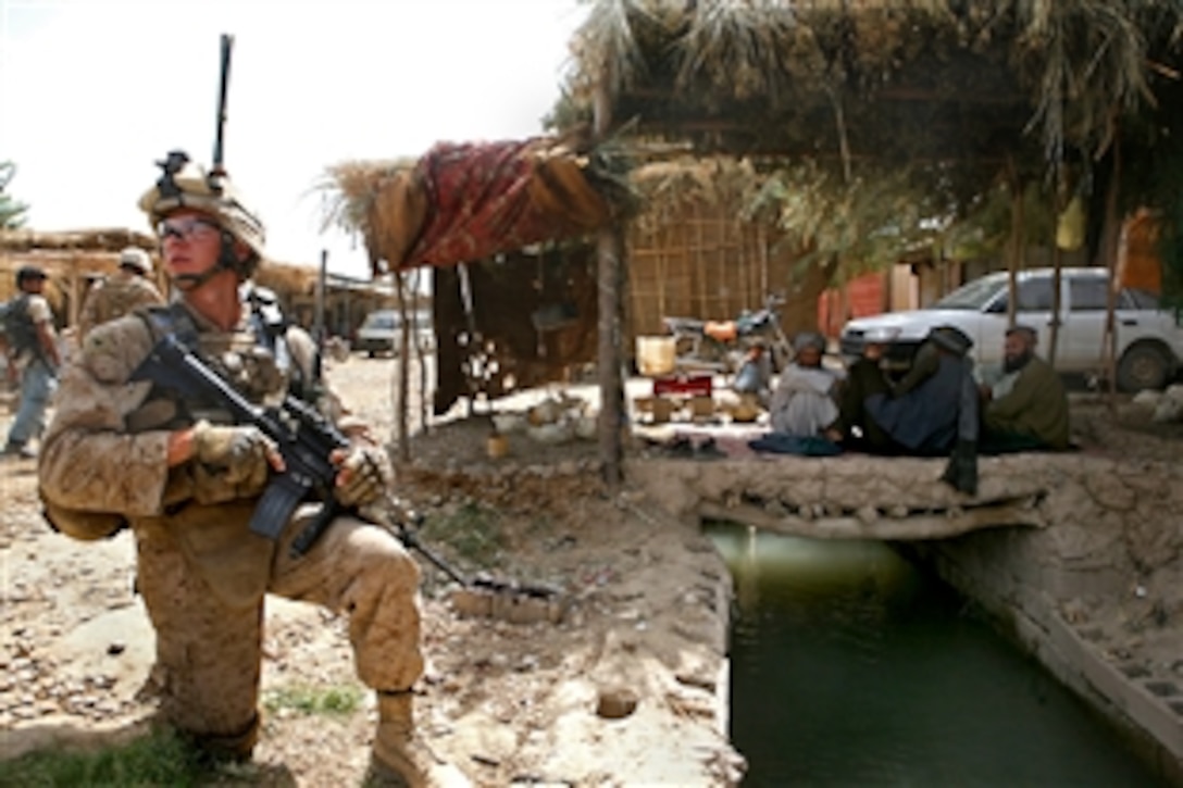 U.S. Marine Corps Lance Cpl. David Petrisor provides security during a patrol through the Koreh Chareh bazaar in Marja, Afghanistan, Aug. 9, 2010. Fox Company escorted Yar Muhammad Barak, the Marja district governor, and Nazar Khan Taukalyar, Marja district education director, to a future school site in the area. Petrisor, a radio operator is assigned to Fox Company, 2nd Battalion, 6th Marine Regiment.