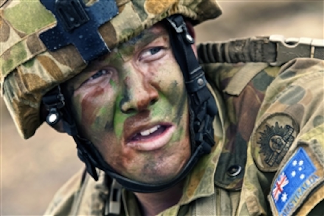 Australian Army Pvt. Lachlan Street listens for directions from his section leader during a mechanized live-fire raid at Range Training Facility Kaneohe Bay, Hawaii, July 30, 2010. The simulated raid was part of Rim of the Pacific 2010 exercise.