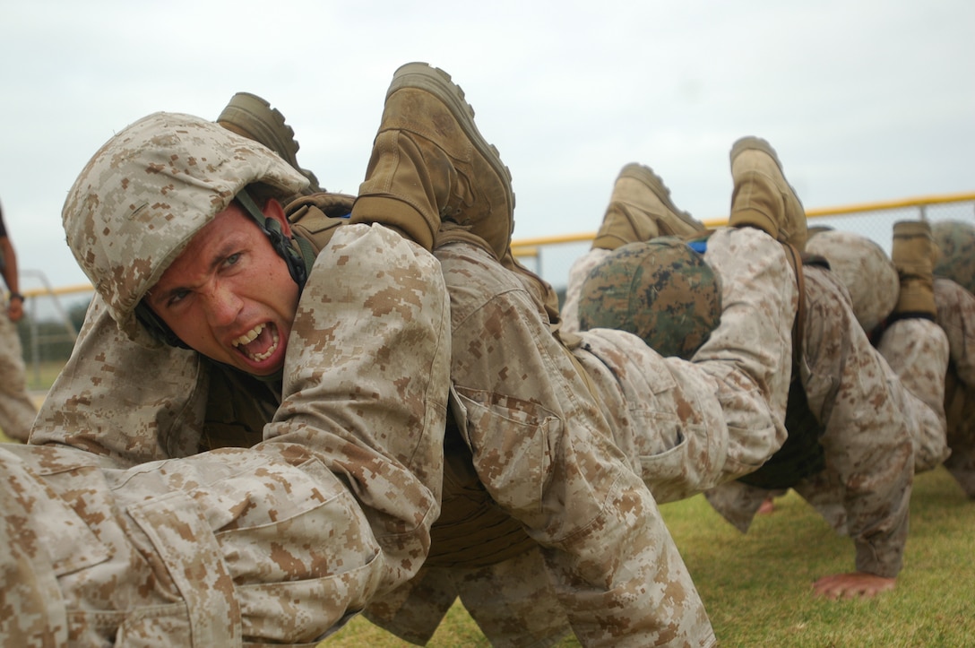 Staff Sgt. Benjamin Maynard, tool room staff noncommissioned officer in charge, Marine Heavy Helicopter Squadron-462, yells commands to his classmates in order to keep their squad push-ups organized.