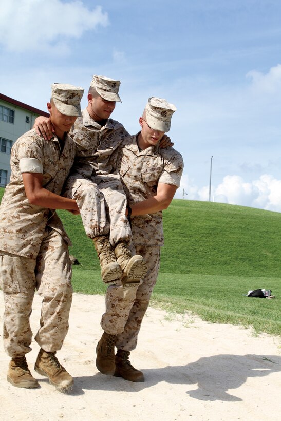 Marines from Headquarters Bn., 3rd MarDiv., play out scenarios to give fellow Marines from 12th Marines, practice tracking as part of a combat hunter course Aug. 11.