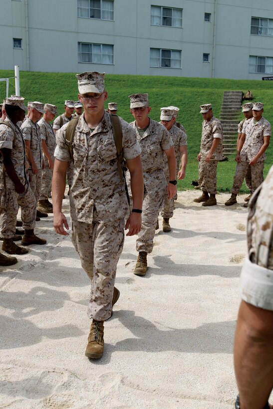 Marines from Headquarters Bn., 3rd MarDiv., play out scenarios to give fellow Marines from 12th Marine Regiment, 3rd MarDiv., practice tracking as part of a combat hunter course Aug. 11.