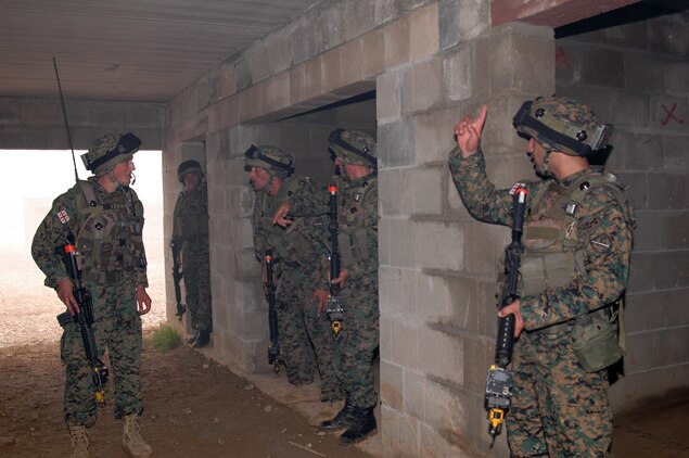 A group of Georgian soldiers search a non-descript building for an Improvised Explosive Device factory in a simulated Afghanistan village at the Joint Multinational Readiness Center here during their situational training exercise. The Republic of Georgia's 32nd Light Infantry Battalion is the second of four battalions to undergo training through the Georgia Deployment Program, a Marine Corps-led initiative designed to prepare the Georgians for their upcoming Afghanistan deployment in support of International Security Assistance Forces there.