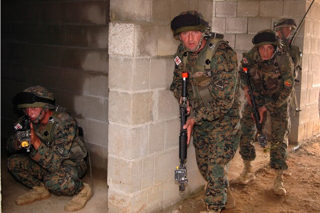 A group of Georgian soldiers search a non-descript building for an Improvised Explosive Device factory in a simulated Afghanistan village at the Joint Multinational Readiness Center here during their situational training exercise. The Republic of Georgia's 32nd Light Infantry Battalion is the second of four battalions to undergo training through the Georgia Deployment Program, a Marine Corps-led initiative designed to prepare the Georgians for their upcoming Afghanistan deployment in support of International Security Assistance Forces there.