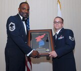 KUNSAN AIR BASE, Republic of Korea -- Senior Master Sgt. Jerome Sydnor, 8th Aircraft Maintenance Squadron weapons superintendent, presents Staff Sgt. Colin Cardwell, 8th Maintenance Squadron, with the Academic Achievement Award during the Kunsan Airman Leadership School Class 10-K graduation here Aug. 6. Sergeant Cardwell was also named a Distinguished Graduate. The class was the first at Kunsan in six years. (U.S. Air Force photo/Senior Airman Roy Lynch)