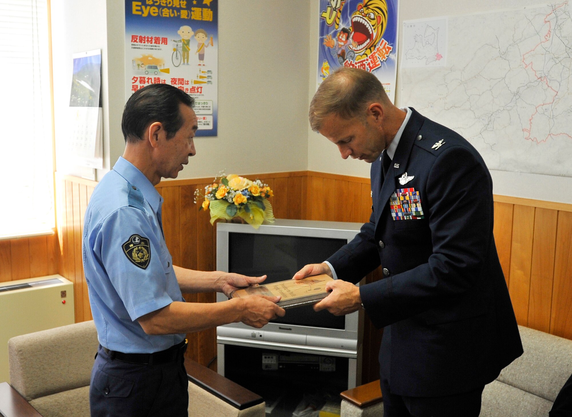Col. RC Craig, 35th Fighter Wing commander, presents the Hachinohe Police Department with a plaque to express his gratitude for their rescue efforts in saving five Misawa Airmen, Aug. 9. Col. Craig, Major Wydra and Chief Hastings visited the Japanese National Police, Hachinohe Fire Department and Coast Guard to thank them for their rescue efforts as well. (U.S. Air Force photo/Staff Sgt. Chad Strohmeyer)