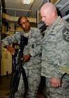 MINOT AIR FORCE BASE, N.D. -- Chief Master Sgt. John L. Hoffman, 91st Missile Wing command chief, talks with Staff Sgt. Nakami Liddell, 5th Security Forces Squadron armory assistant noncommissioned officer-in-charge, about her duties in the armory here Aug. 11. Chief Hoffman has taken over the reigns as the new 91st MW command chief and has the welfare of his Airmen as a number one priority. The chief is visiting various units around base to get to know both the Rough Riders and Warbirds of Minot AFB. (U.S. Air Force photo by Senior Airman Benjamin Stratton)