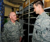 MINOT AIR FORCE BASE, N.D. -- Chief Master Sgt. John L. Hoffman, 91st Missile Wing command chief, talks with Senior Airman Steven Boatright, 91st Security Support Squadron armorer, about his duties in the armory here Aug. 11. Chief Hoffman has taken over the reigns as the new 91st MW command chief and has the welfare of his Airmen as a number one priority. The chief is visiting various units around base to get to know both the Rough Riders and Warbirds of Minot AFB. (U.S. Air Force photo by Senior Airman Benjamin Stratton)