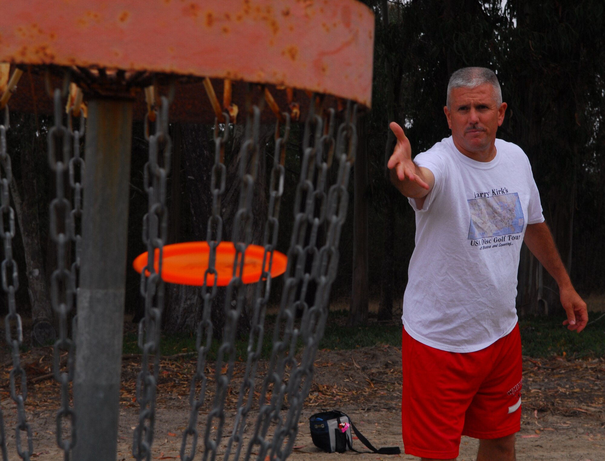 VANDENBERG AIR FORCE BASE, Calif. – Following his toss, Tech. Sgt. Larry Kirk, a 30th Security Forces Squadron patrolman, nails the basket (his target) at Vandenberg’s disc golf course here Wednesday, Aug. 11, 2010. Vandenberg’s disc golf course is free and open to all personnel with base access. (U.S. Air Force photo/Senior Airman Steve Bauer) 
