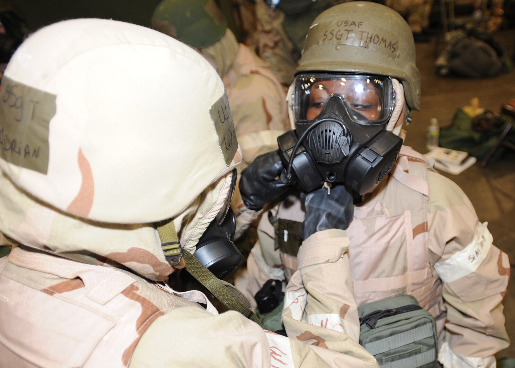 Staff Sgt. Adrian Wilson, 27th Special Operations Logistics Readiness Squadron, assists Staff Sgt. Zenetra Thomas, 27 SOLRS, with her chemical gear. Using the Wingman concept ensures an Airman is equipment is properly fitted and secure. (U.S. Air Force photo by Airman 1st Class Maynelinne De La Cruz)