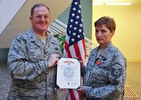 MINOT AIR FORCE BASE, N.D. -- Master Sgt. Judy McClure, 5th Medical Operations Squadron operational medicine flight chief, receives the Air Force Combat Action Medal here Aug. 6. Sergeant McClure was recognized for her dedicated service while part of a medical evacuation sortie during a recent deployment to Afghanistan. (U.S. Air Force photo by Senior Airman Michael J. Veloz)