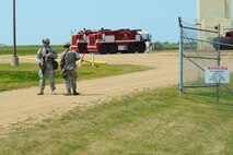 MINOT AIR FORCE BASE, N.D. -- Senior Airmans Stephen Burt and Brent Thielemier, both 5th Security Forces Squadron response force team members, take up defensive positions during a major accident response exercise here Aug. 5. The MARE simulated an event where multiple base agencies were tested on response time and capabilities. (U.S. Air Force photo by Airman 1st Class Aaron-Forrest Wainwright)