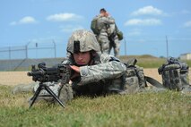 MINOT AIR FORCE BASE, N.D. -- Airman 1st Class Micah Stuber, 5th Security Forces Squadron response force team member, takes a defensive position during a major accident response exercise as part of Prairie Vigilance 10-6 here Aug. 5. The MARE simulated an event where multiple base agencies were tested on response time and capabilities. (U.S. Air Force photo by Airman 1st Class Aaron-Forrest Wainwright)