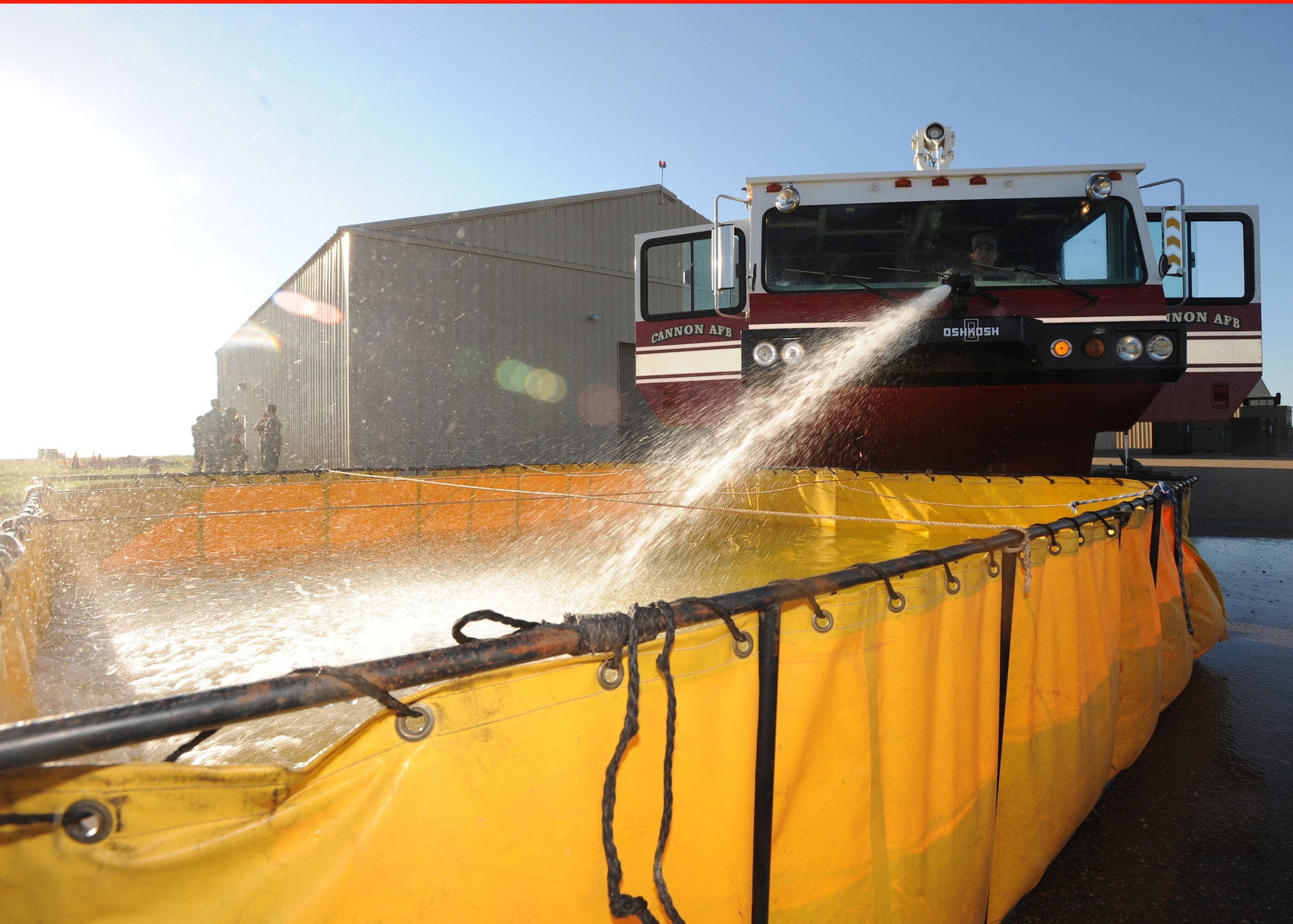 Firefighters from the 27th Special Operations Civil Engineer Squadron fill a portable water tank Aug. 9, 2010 during an Operational Readiness Exercise at Cannon Air Force Base, N.M. In a deployed location there may be no fire hydrants or nearby lakes, so filling up the tank provides easy water access for Airman. (U.S. Air Force photo by Airman 1st Class Maynelinne De La Cruz)