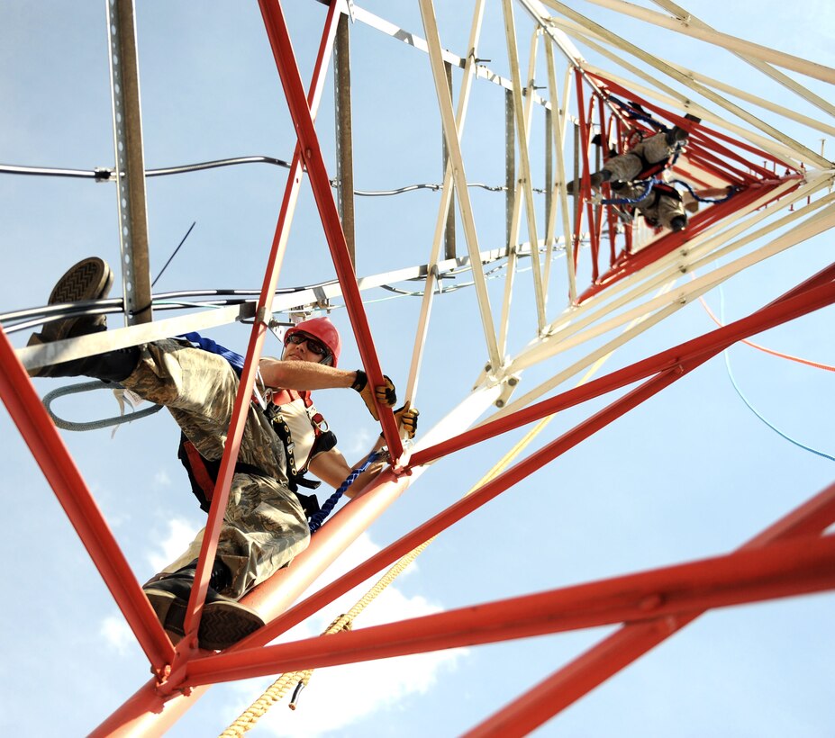 Airmen make their way up the communications tower July 22, 2010, at F.S. Gabreski Air National Guard Base in Westhampton Beach, N.Y., to improve the grounding system and install a lightning mast and two new multiband antennas.   They are assigned to the New York Air National Guard's 213th Engineering Installation Squadron at nearby Stewart ANGB in Newburgh.  (U.S. Air Force photo/Staff Sgt. David J. Murphy)