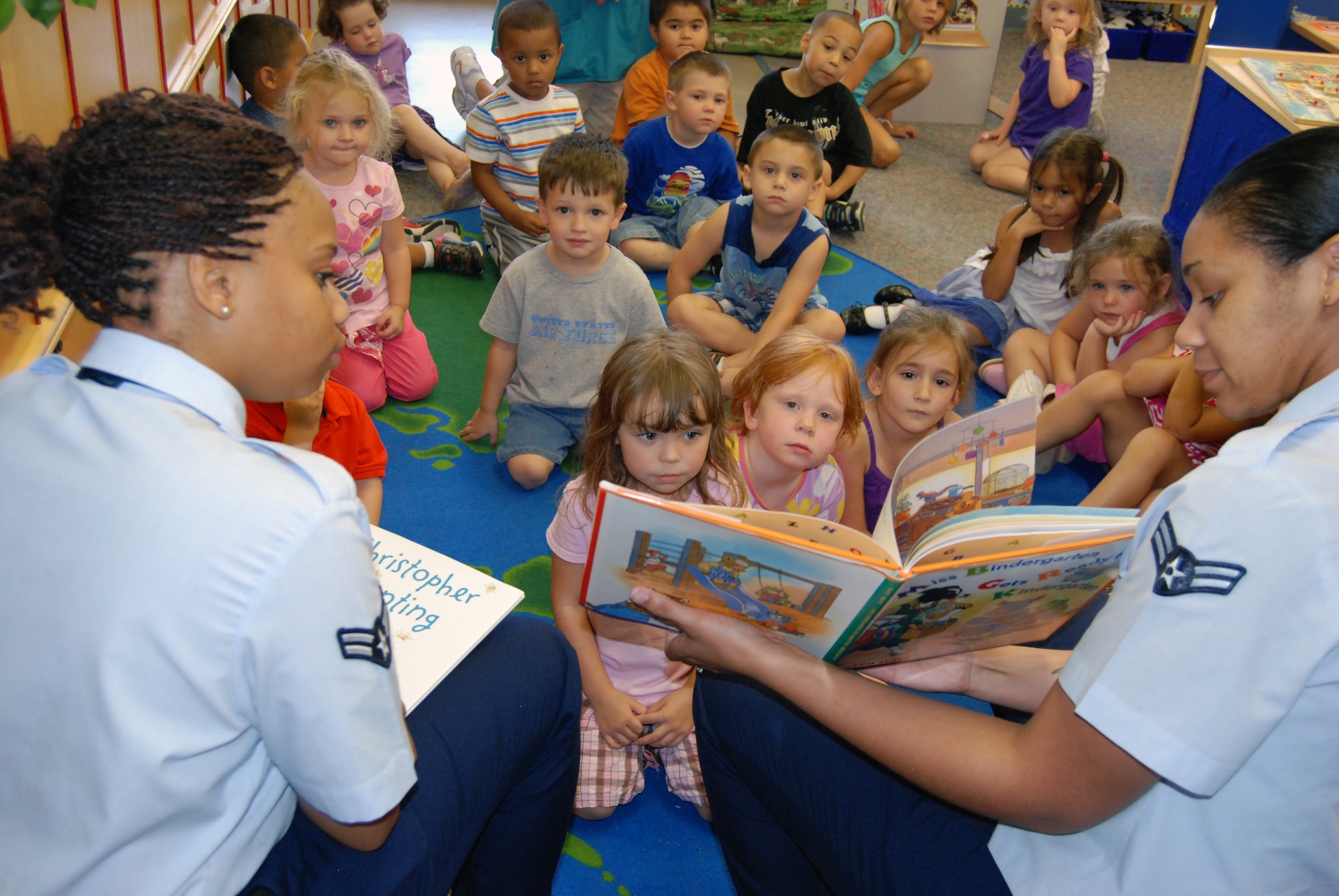 Volunteers from Sheppard’s 54321 Read program read several stories to the three-to-five-year-olds during story time at the Child Development Center at Sheppard Air Force Base, Texas, Aug. 9.  Airman 1st Class Monica Reed (left), 82nd Force Support Squadron student relocations counselor, and Airman 1st Class Krystal Morris(right), 80th Flying Training Wing personnel journeyman, took turns reading various short stories during their biweekly tour of the CDC.  (U.S. Air Force photo/Tech. Sgt. Vernon Cunningham)
