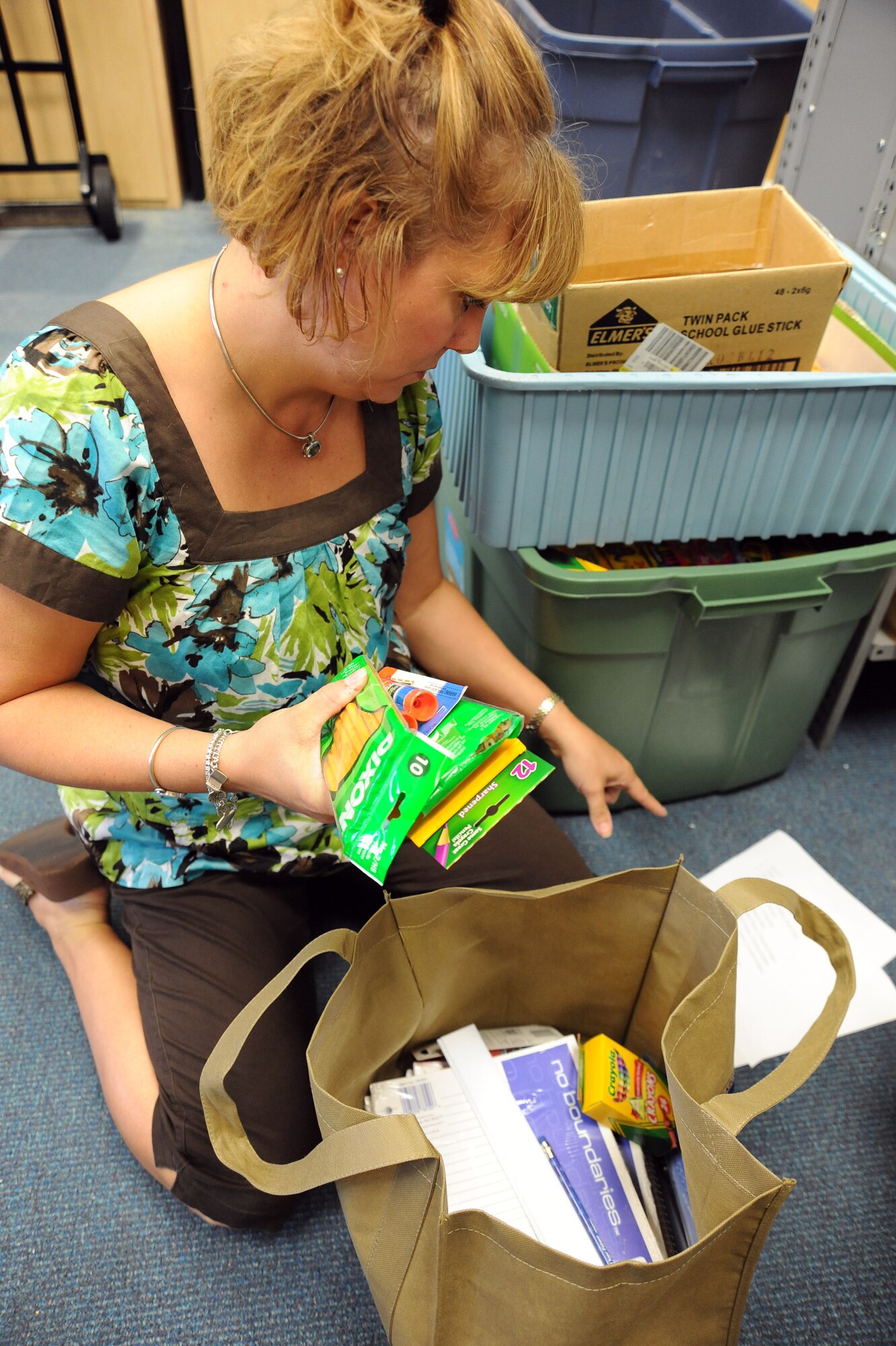 Chris Lee, Airman and Family Readiness Center Family Services coordinator, fills a bag full of school supplies at the Airman’s Attic Aug. 10, 2010. Ms. Lee compiled more than 400 bags for young children and 85 bags for college students for this year’s school supply give-away. The supplies in the bags have equipment necessary to fill a school supply list. (U.S. Air Force photo/ Senior Airman Courtney Witt)