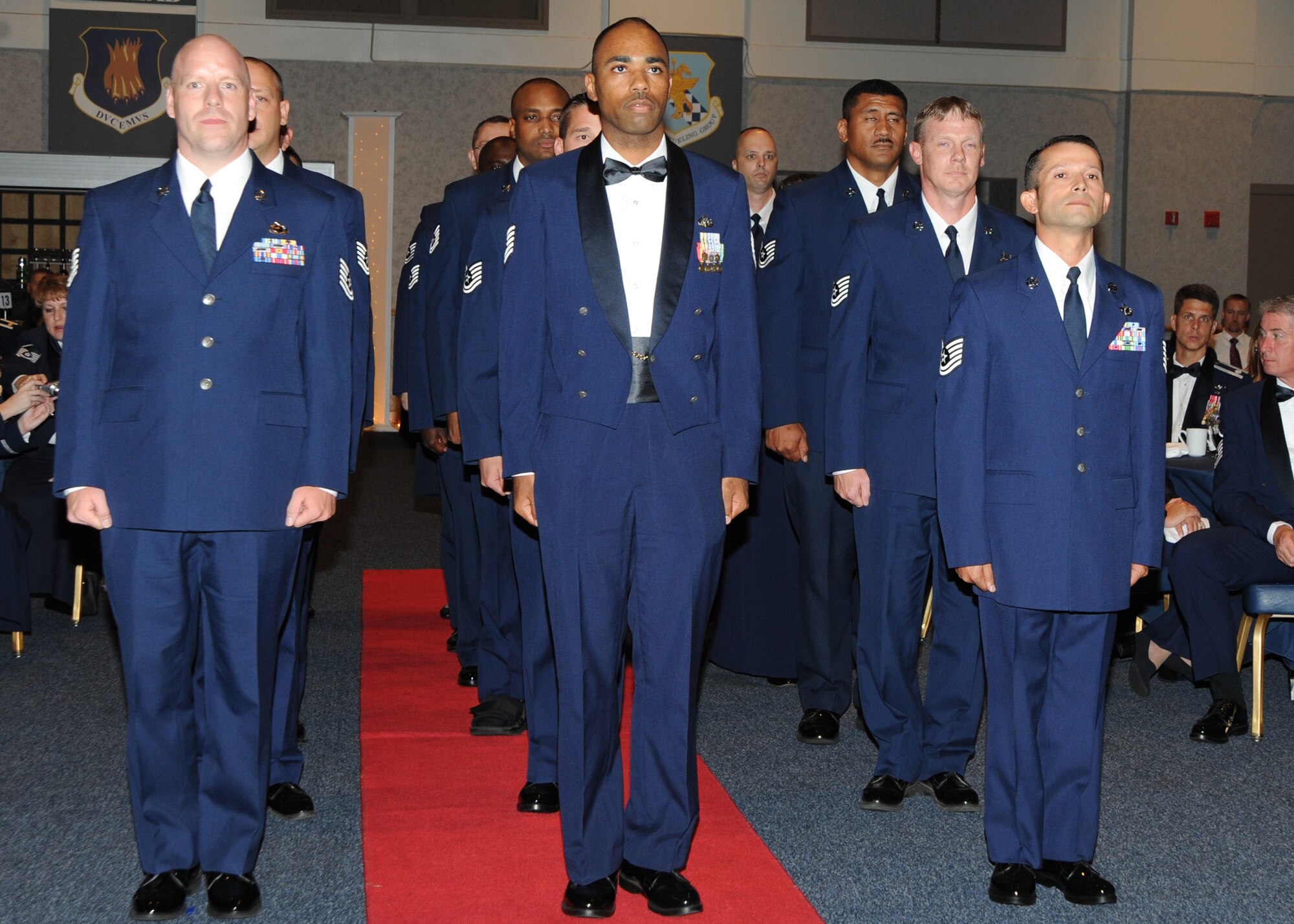 SNCO inductees stand in formation before the awards presentation for the SNCO induction ceremony held at the Robert J. Dole Community Center, Aug. 7, 2010, McConnell Air Force Base, Kan.   The ceremony recognizes individuals who progress through the ranks and have been selected for master sergeant promotion transitioning them to the senior leadership level.  More than 40 technical sergeants were recognized during the event as they prepare to enter the Air Force SNCO corps.  (U.S. Air Force photo/Airman 1st Class Andrea Salazar)