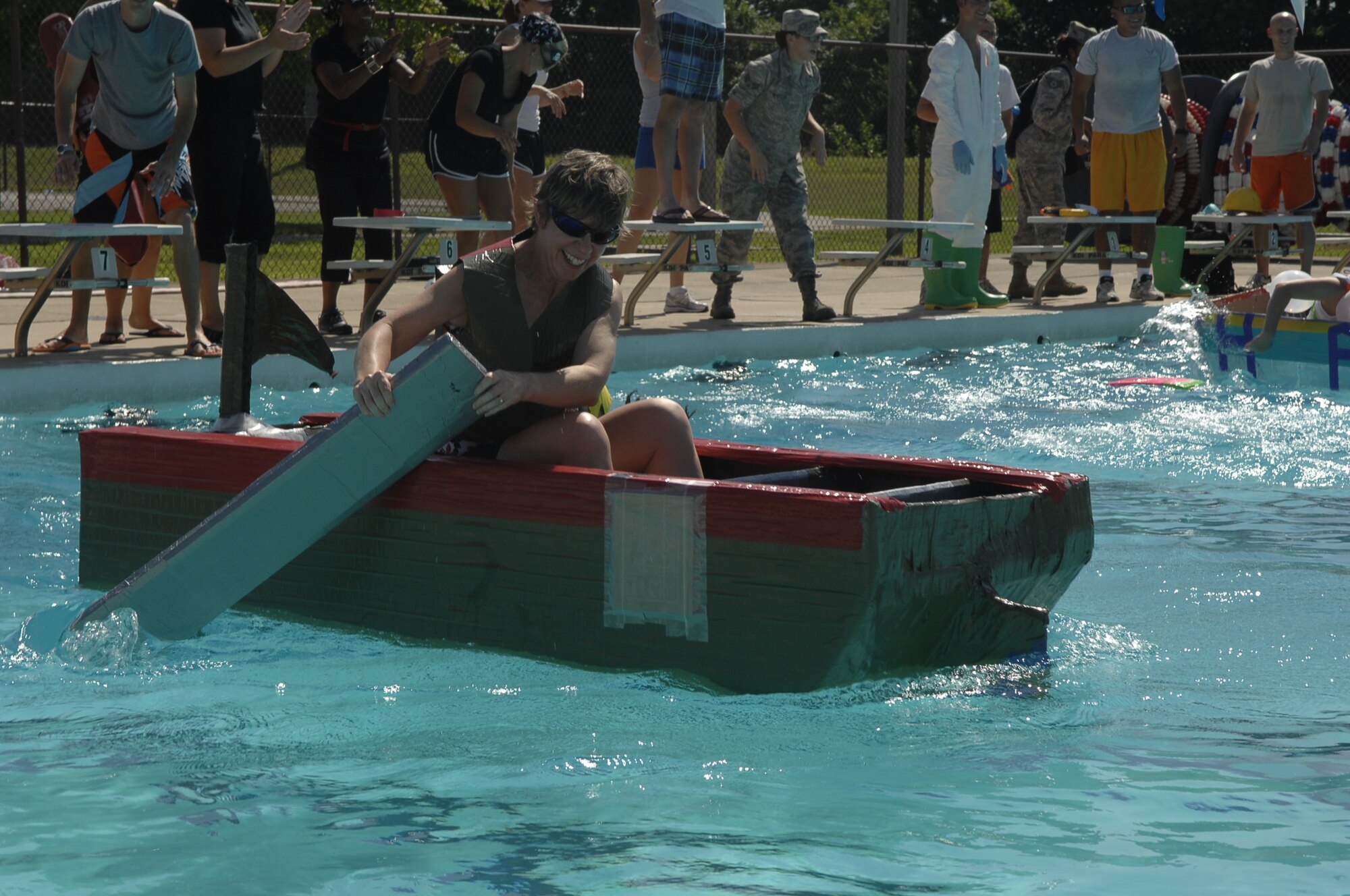 SCOTT AIR FORCE BASE, Ill. -- Lt. Col. Alice Chapman, 375th Medical Group command team, paddles her boat during the duct tape regatta.  The 375th MDG created the fun competition to build morale within the group. (U.S. Air Force Photo by Alice Munoz-Cook)
