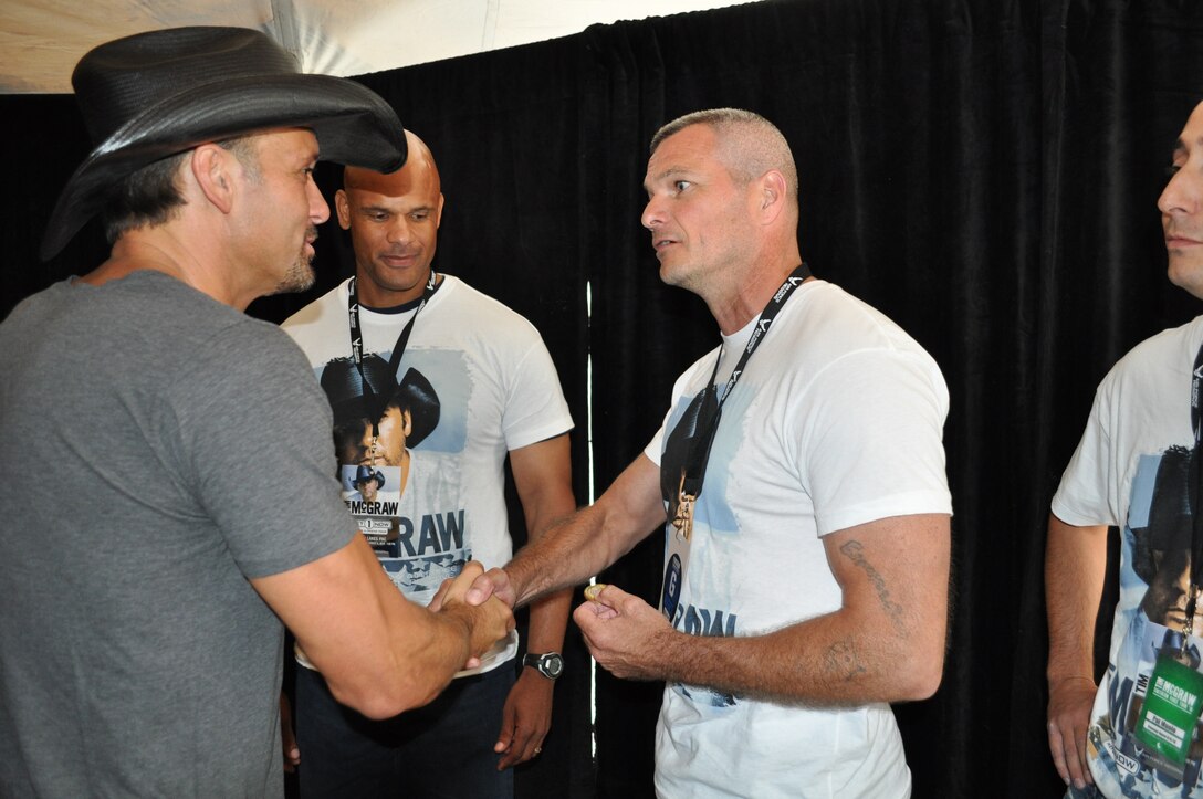 914th Maintainence Group Superintendent Chief Master Sgt. Stephen Trosterud presents the 914 Airlift Wing Command Chief coin to Tim McGraw at his concert at Darien Lake, NY August 6.