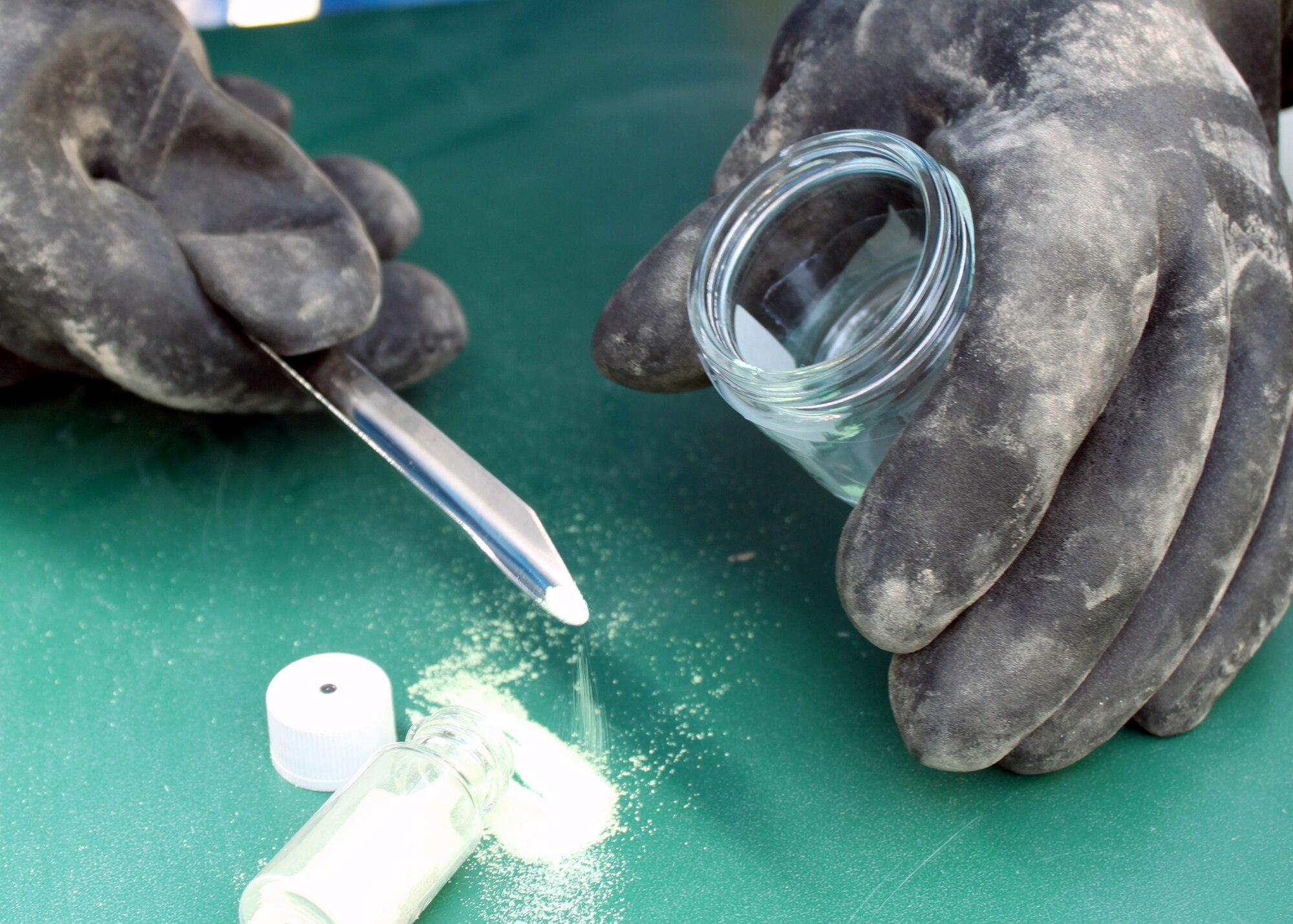 Senior Airman Nathan Krajcirik takes a sample of an unknown powder during training Aug. 3, 2010, at Joint Base Balad, Iraq. Different powders, pastes, liquids and aerosols are frequently used in training, so that during a real-world incident Emergency management Airmen are able to put their training to use. Airman Krajcirik is a 332nd Civil Engineer Squadron Emergency Management Section technician. (U.S. Air Force photo/Staff Sgt. Stacy Fowler)