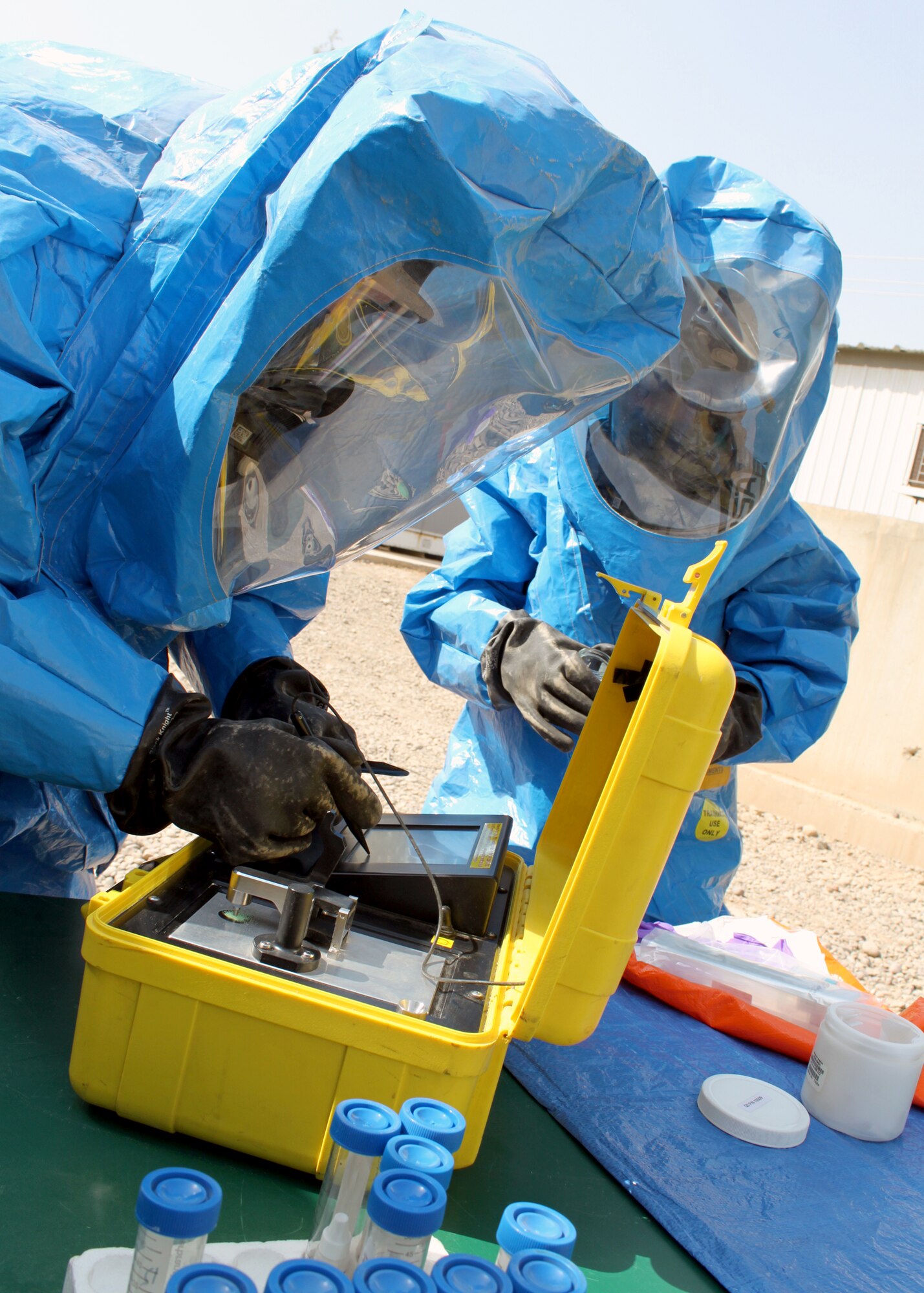 Senior Airmen Nathan Krajcirik (left) and Nadege James test a powder using a piece of equipment called "HAZMAT ID" during training Aug. 3, 2010, at Joint Base Balad, Iraq. Airmen Krajcirik and James are 332nd Civil Engineer Squadron Emergency Management Section technicians. (U.S. Air Force photo/Staff Sgt. Stacy Fowler) 