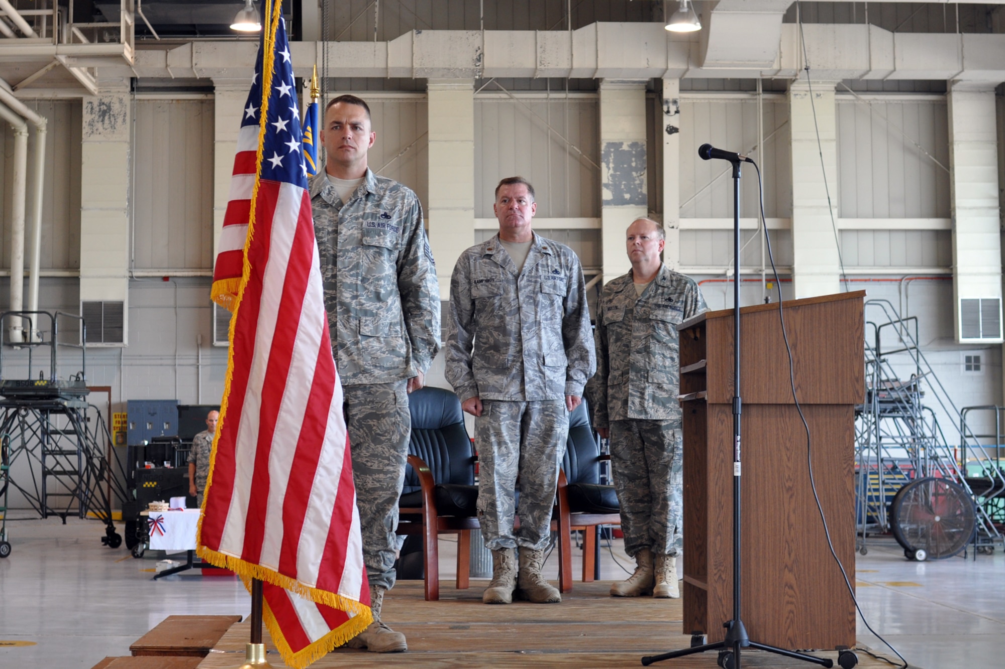Chief Master Sgt. Derek K. Conrad, maintenance supervisor, 917th Maintenance Squadron, Maj. Leo J. Kamphaus Jr., commander,917 MXS and Col. Jeffrey S. Mullen, commander, 917th Maintenance Group stand tall during the national anthem at the 917 MXS assumption of command ceremony at Barksdale Air Force Base, La., August 7, 2010. Colonel Mullen presided over the ceremony during which Major Kamphaus assumed command of the unit. (U.S. Air Force photo/Senior Airman Crystal Marie Jordan)