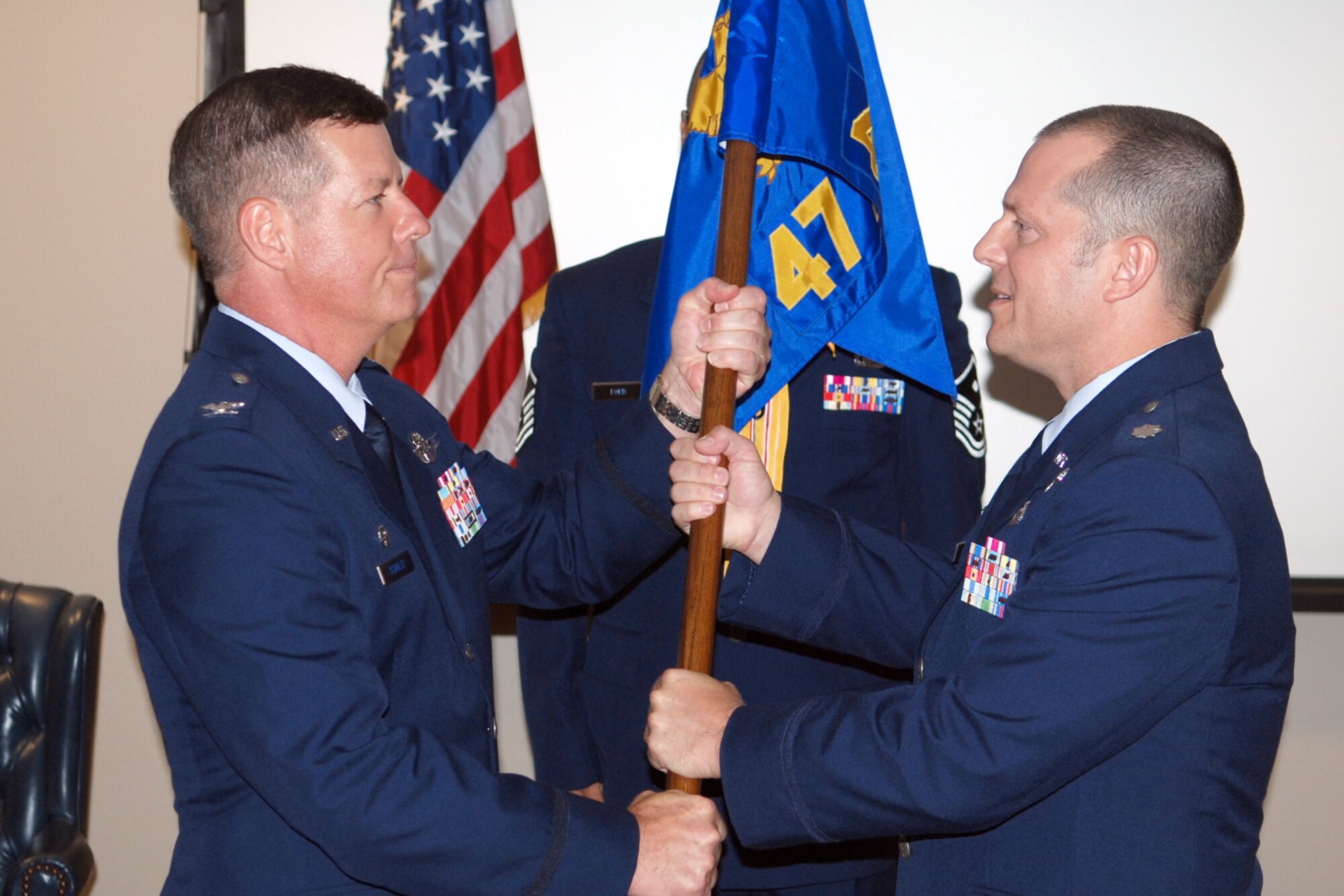 Col. Keith Schultz, commander, 917th Operations Group, passes the 47th Fighter Squadron guidon to Lt. Col. James Travis, 917th Operations Support Flight commander, who assumed command of the 47th FS, at Barksdale Air Force Base, La., August 7, 2010. (U. S. Air Force photo/Master Sgt. Greg Steele)

