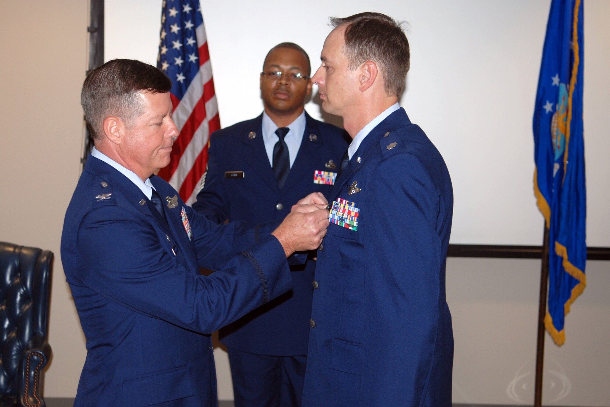 Col. Keith Schultz, commander, 917th Operations Group, presents The Meritorious Service Medal to Lt. Col. John Russell, 47th Fighter Squadron commander, during the 47th FS Change of Command ceremony at Barksdale Air Force Base, La., August 7, 2010. Lt. Col. Russell relinquished command of the 47th FS to Lt. Col. James Travis. (U. S. Air Force photo/Master Sgt. Greg Steele)