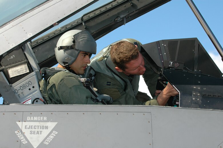 Capt. Craig Baker (right), 555th Fighter Squadron pilot, covers a few safety precautions with Tech. Sgt. Sergio Sanchez, 555th FS aviation management, before flying together on a familiarization flight in an F-16 Aug. 5, 2010 at Kallax Air Base, Sweden. The 555th FS spent two weeks working with the Swedish air force at Norrbotten Wing conducting air-to-air and air-to-ground training missions. (U.S. Air Force photo by Tech. Sgt. Lindsey Maurice/Released) 
