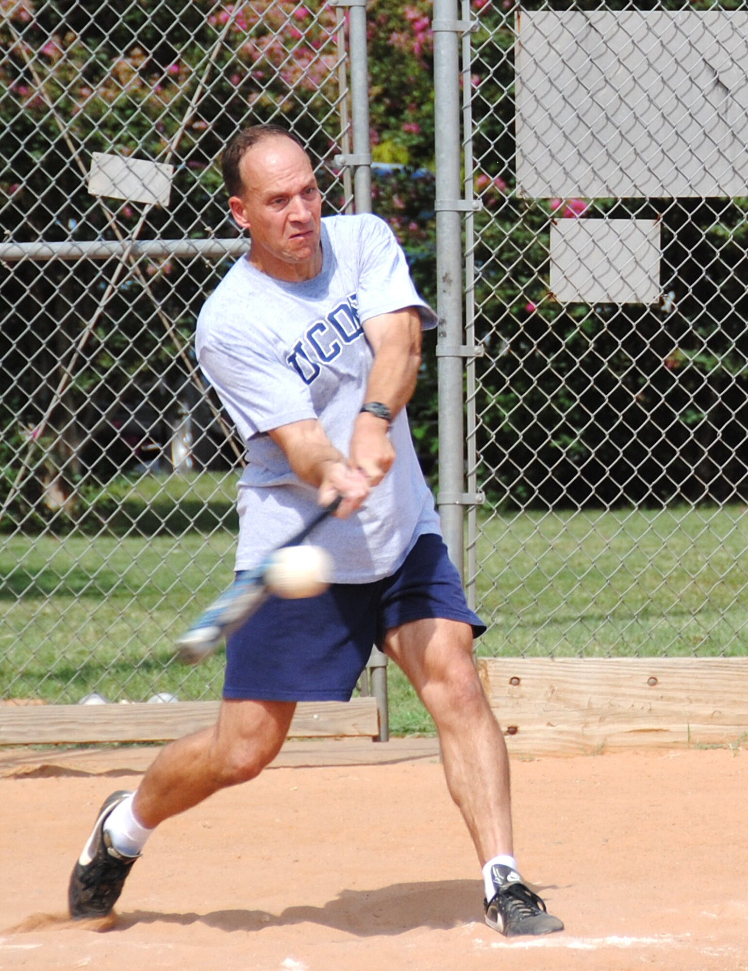 Col. Douglas Curry, 71st Medical Group commander, grabs a piece of the ball during the Focus 5/6 Second Annual Softball Classic played Aug. 6 on the Vance softball field. The Senior Leadership team lost to the Company Grade Officers during the first game of the classic. (U.S. Air Force photo/ Joe B. Wiles)