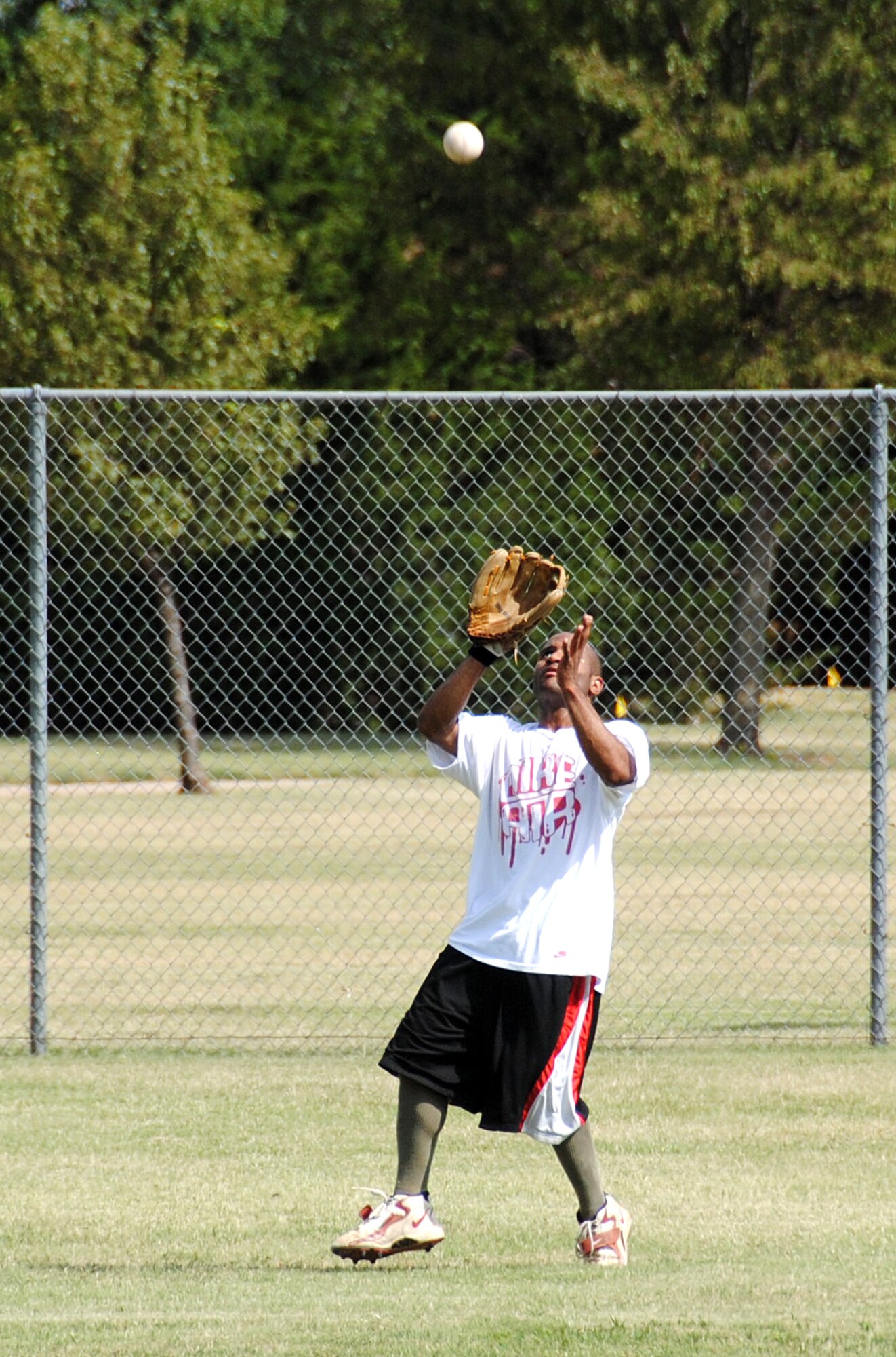 First Lt. Chris Smith, 71st Force Support Squadron, fields a long-fly ball for the Company Grade Officers team during the Focus 5/6 Second Annual Softball Classic played Aug. 6 on the Vance softball field. The junior officers won the first game with 16 runs. (U.S. Air Force photo/ Joe B. Wiles)