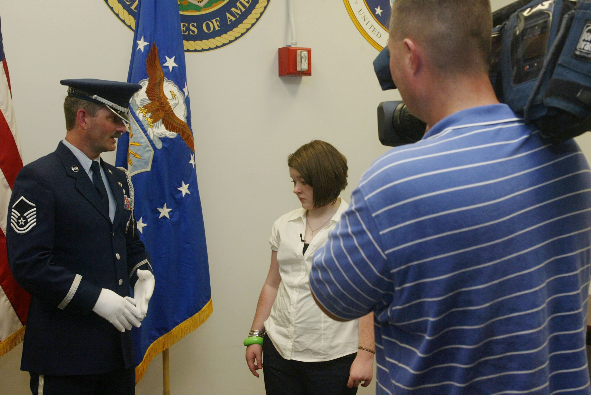 Master Sgt. Bruce See from the 94th Airlift Wing Honor Guard instructs Angela on the proper way to render a salute. She was treated to a performance by the drill team as well during her tour of the base on Aug. 4. Wednesday’s Child is a partnership of the Freddie Mac Foundation, WAGA Fox 5 Atlanta, and the Georgia Department of Family and Children Services Adoption Unit, formed to help families for children in foster care or with special needs who are available for adoption.  (U.S. Air Force Photo/Don Peek)