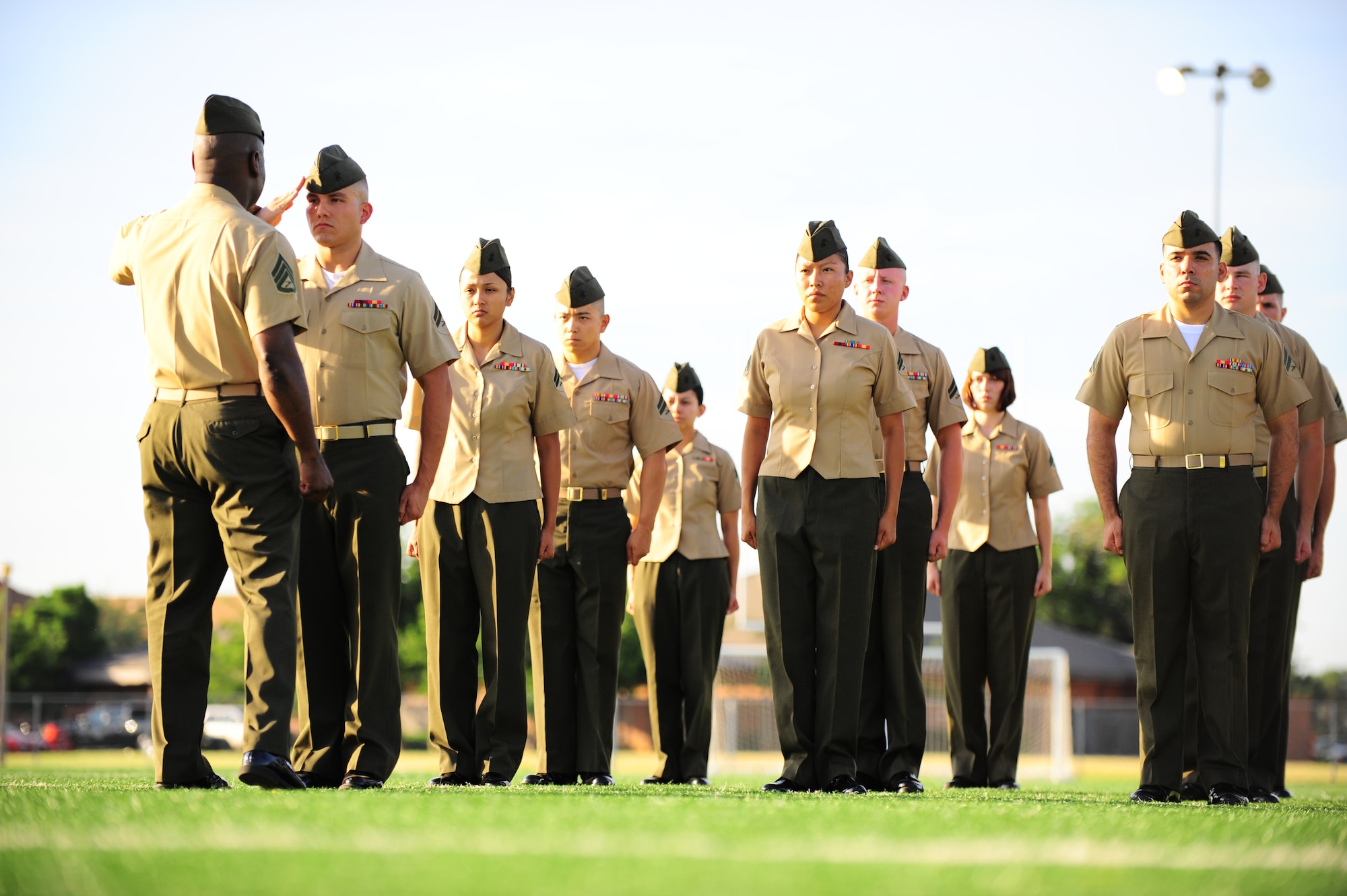 DYESS AIR FORCE BASE, Texas—Marine Staff Sgt. Tommy Tillman instructs a formation of Marine corporals here Aug. 5.Twenty-eight Marine corporals stood in formation on the fitness center football field to be inspected in their uniforms by instructors. The Marine’s Enlisted Professional Military Education course, “Corporals Course”, commenced for the first time at Dyess. The 16-day course teaches young Marine noncommissioned officers (corporals) how to lead in today’s Marine Corps in garrison and in theater. (U.S. Air Force photo/ Senior Airman Domonique Washington) 