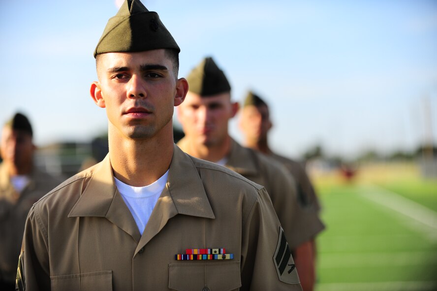DYESS AIR FORCE BASE, Texas -- Marine Cpl. Colbi Stowers, Corporals Course student, prepares to be inspected by his instructor here Aug. 5. Twenty-eight Marine corporals stood in formation on the fitness center football field to be inspected in their uniforms by instructors. The Marine’s Enlisted Professional Military Education course, known as “Corporals Course," commenced for the first time at Dyess. The 16-day course teaches young Marine NCOs (corporals) how to lead in today’s Marine Corps in garrison and in theater. (U.S. Air Force photo/Senior Airman Domonique Washington)