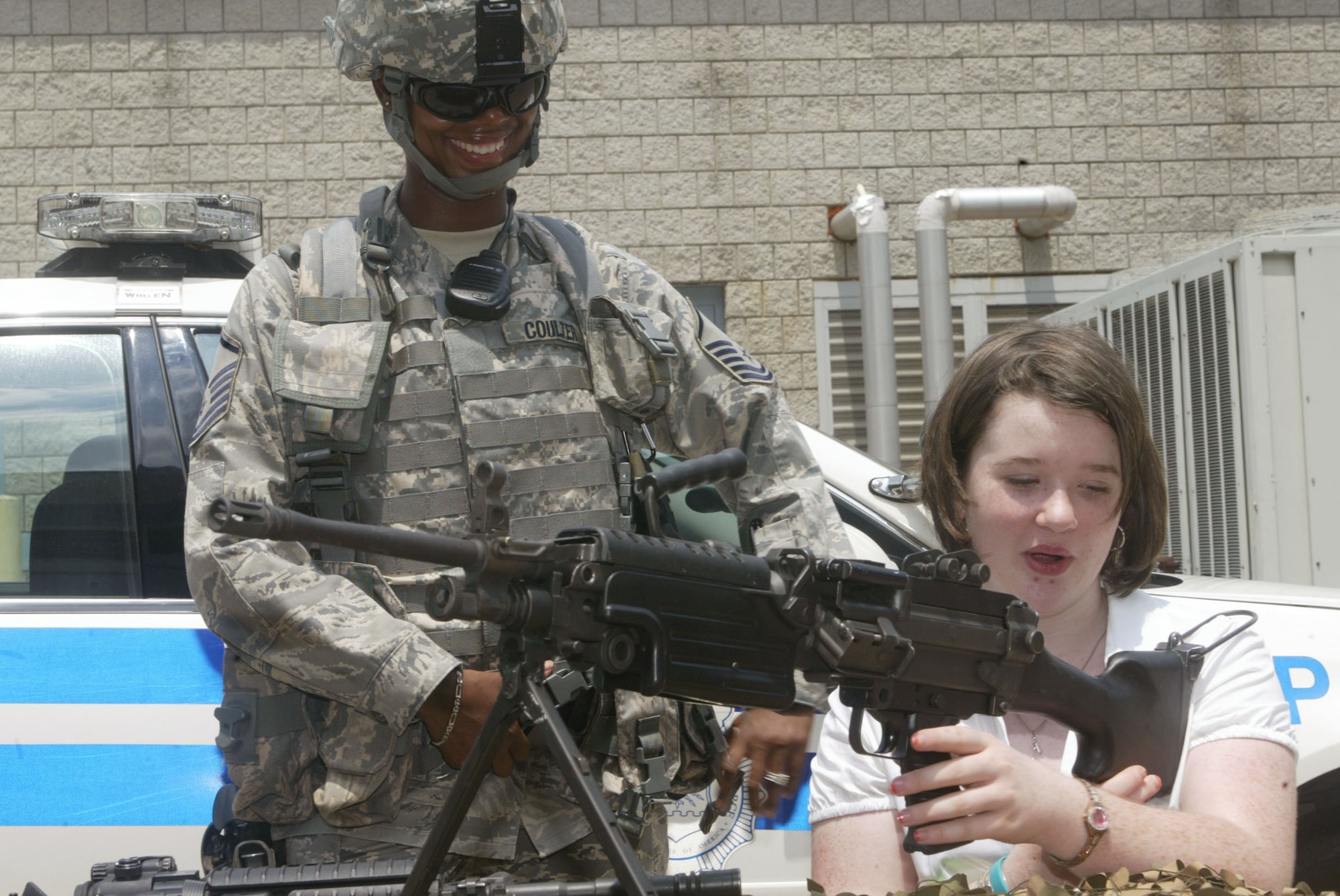 Master Sgt. Engle Coulter of the 94th AW Security Forces Squadron explains her job to the week’s Wednesday’s Child feature, Angela. Wednesday’s Child is a partnership of the Freddie Mac Foundation, WAGA Fox 5 Atlanta, and the Georgia Department of Family and Children Services Adoption Unit, formed to help families for children in foster care or with special needs who are available for adoption.  (U.S. Air Force Photo/Don Peek)